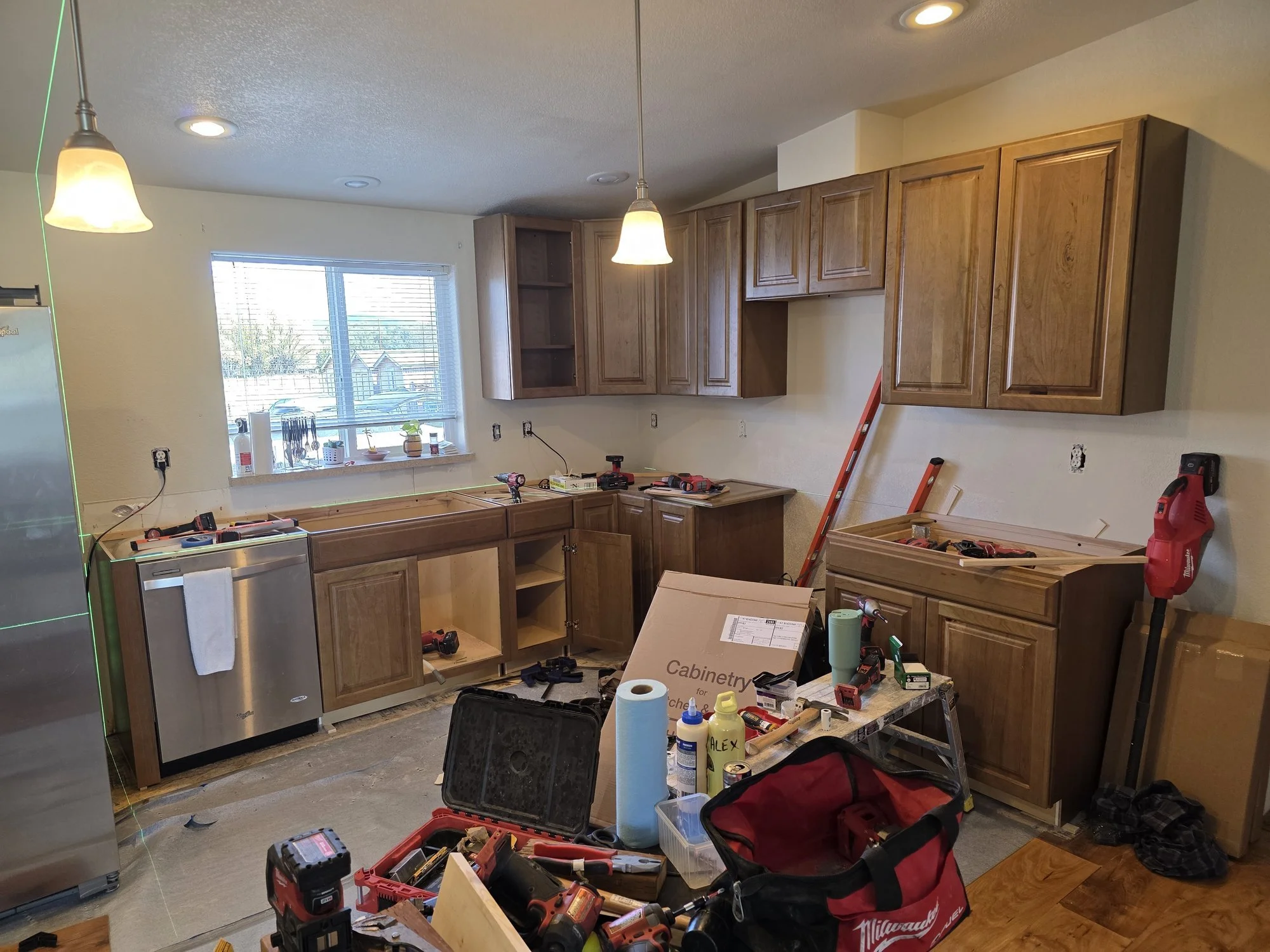 Laser level set for hanging the upper kitchen cabinets dead level, Anaconda, MT