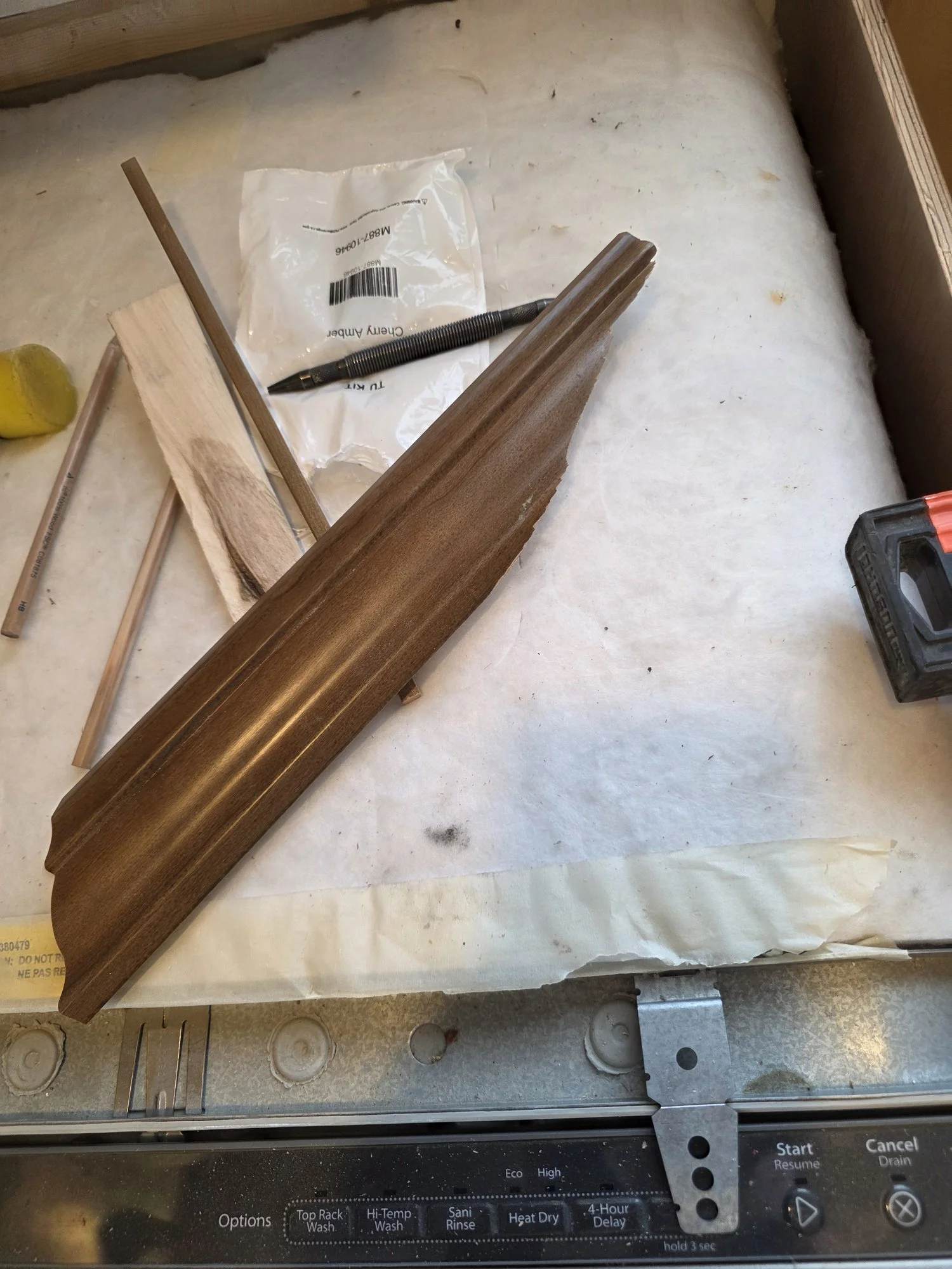 Cherry Amber stained crown molding ready to install on the kitchen cabinets, Anaconda, Montana