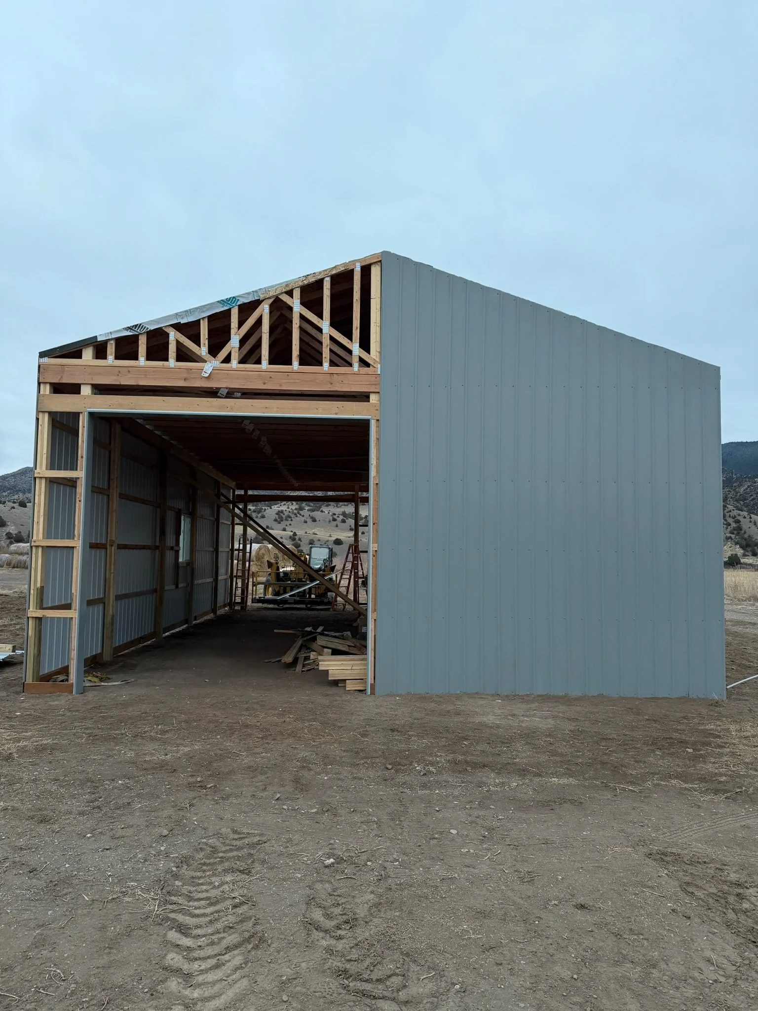 Steel siding going on the pole barn, Cardwell, Montana