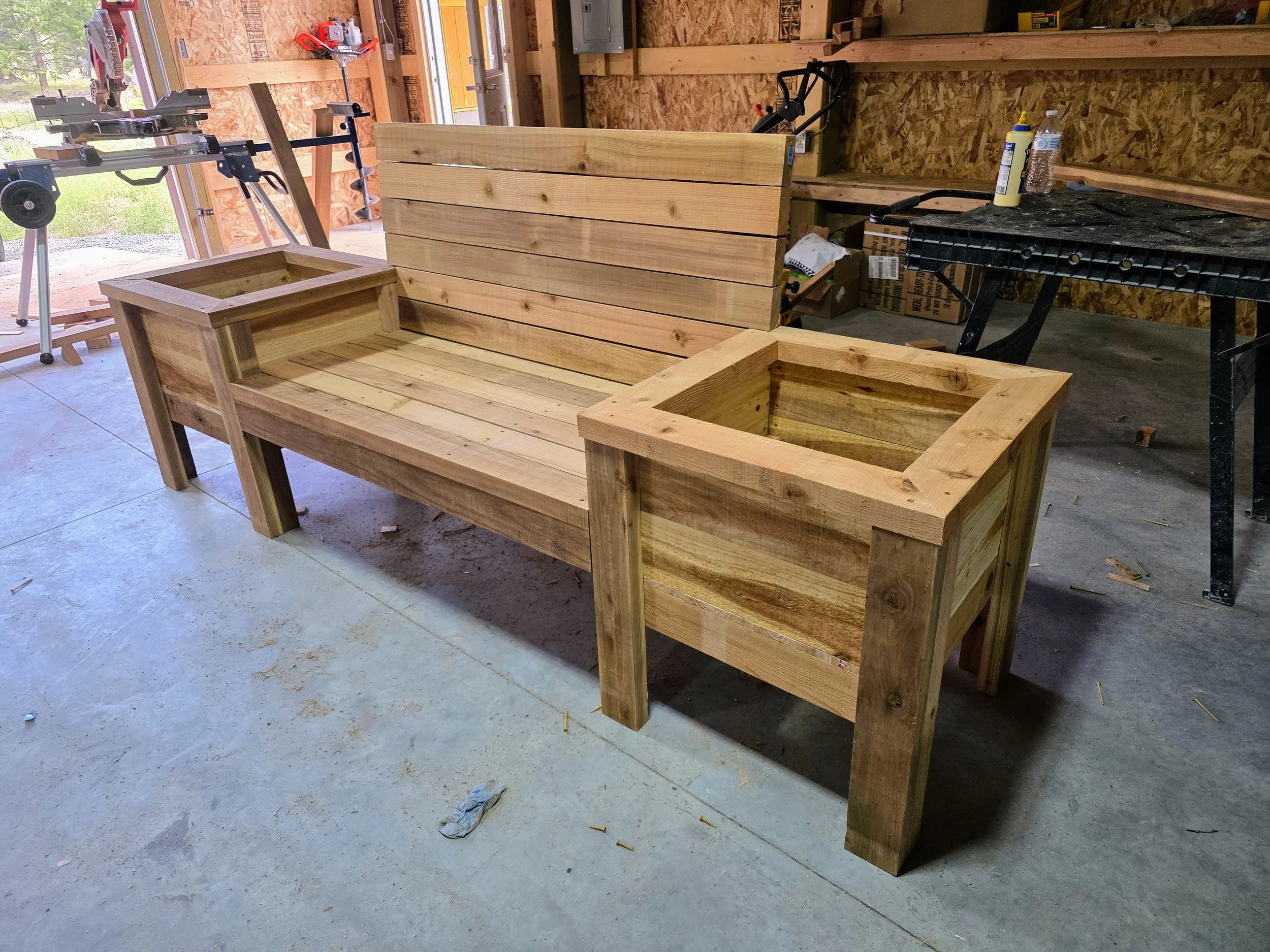 Finished cedar planter bench with backrest, ready for delivery