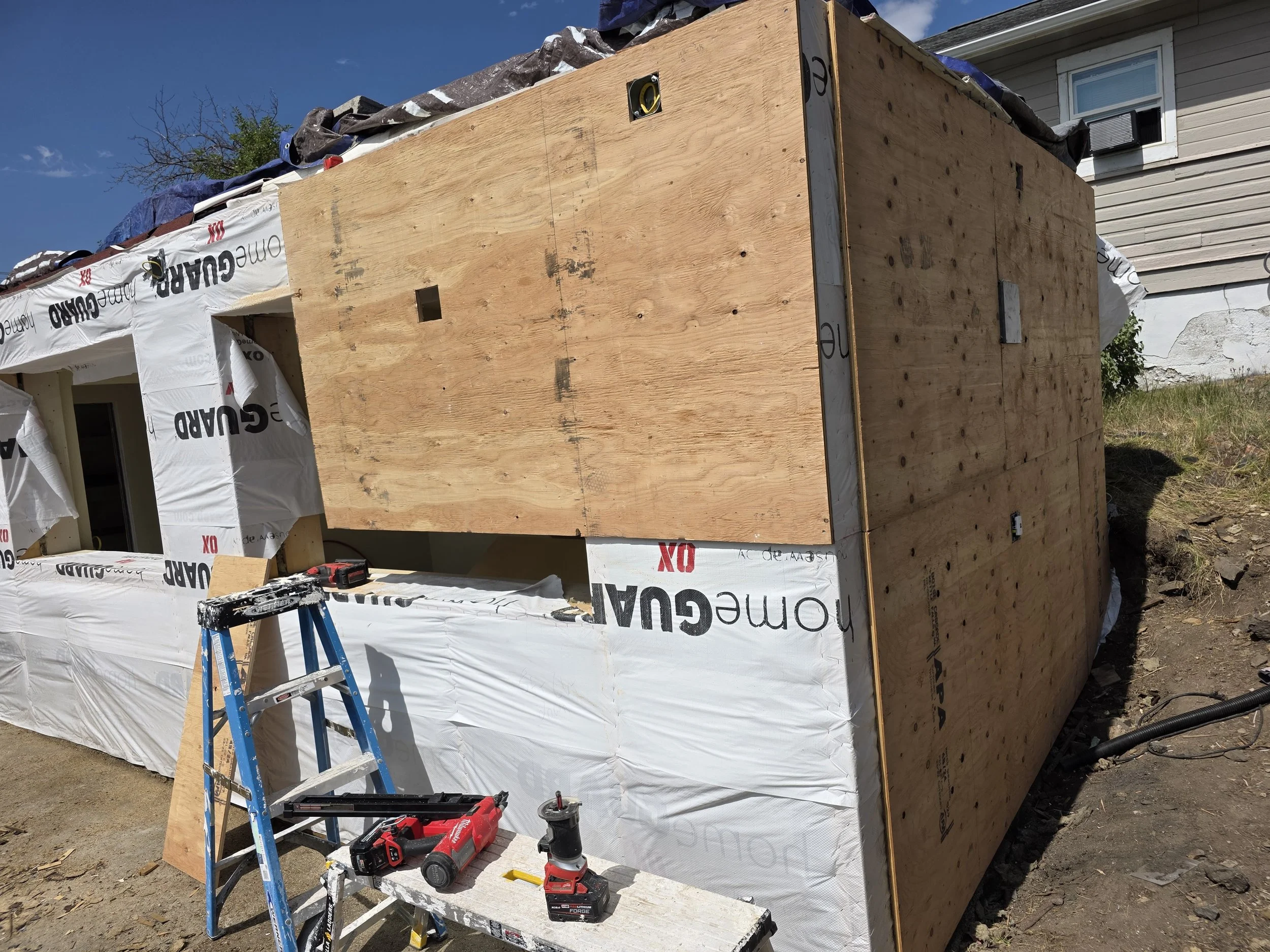 Addition sheathed with house wrap going on, Uptown Butte, Montana