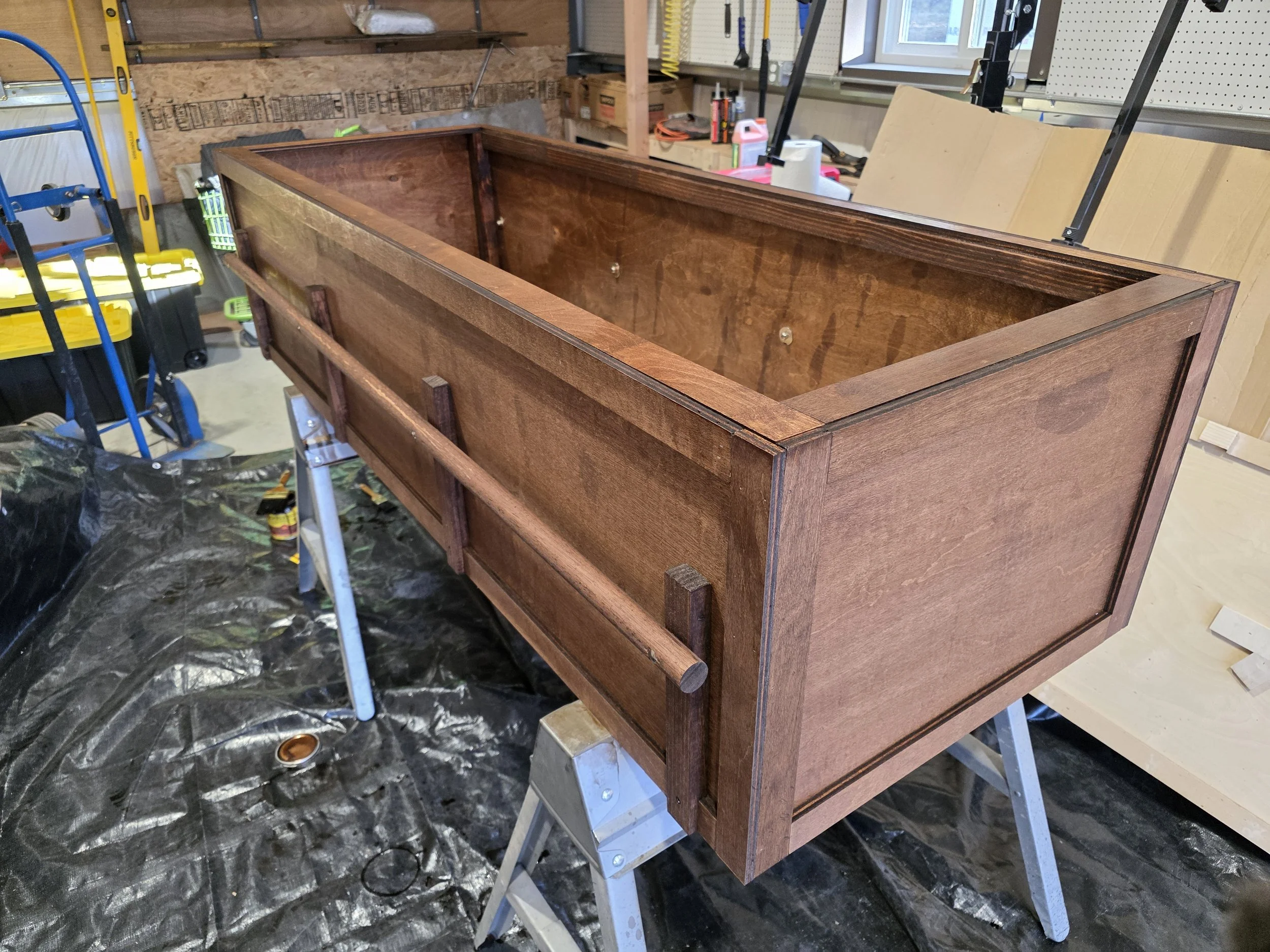 Stained wooden casket with carry rails, Butte, Montana