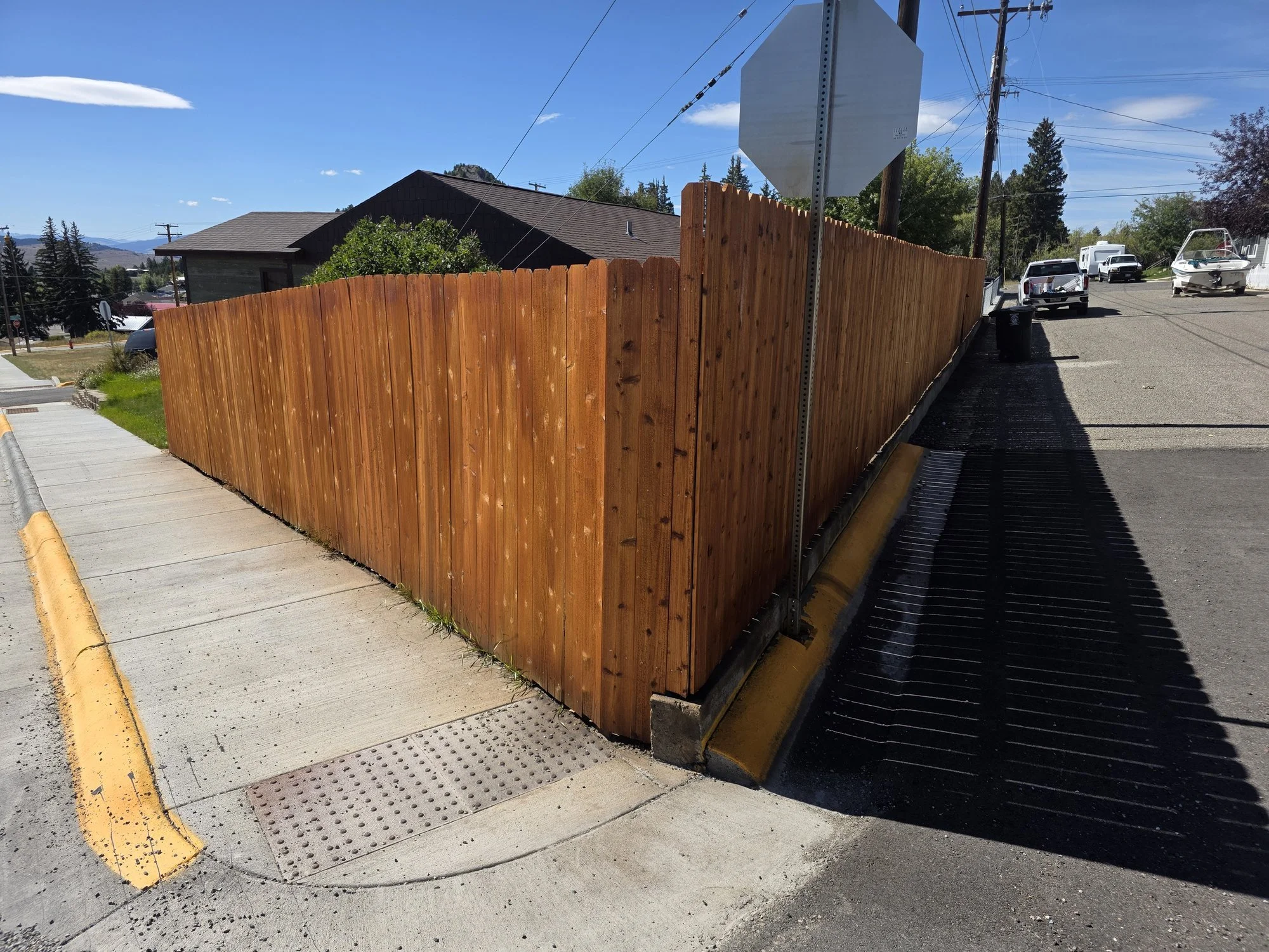 Stained cedar privacy fence at the corner of the lot, Walkerville, Montana