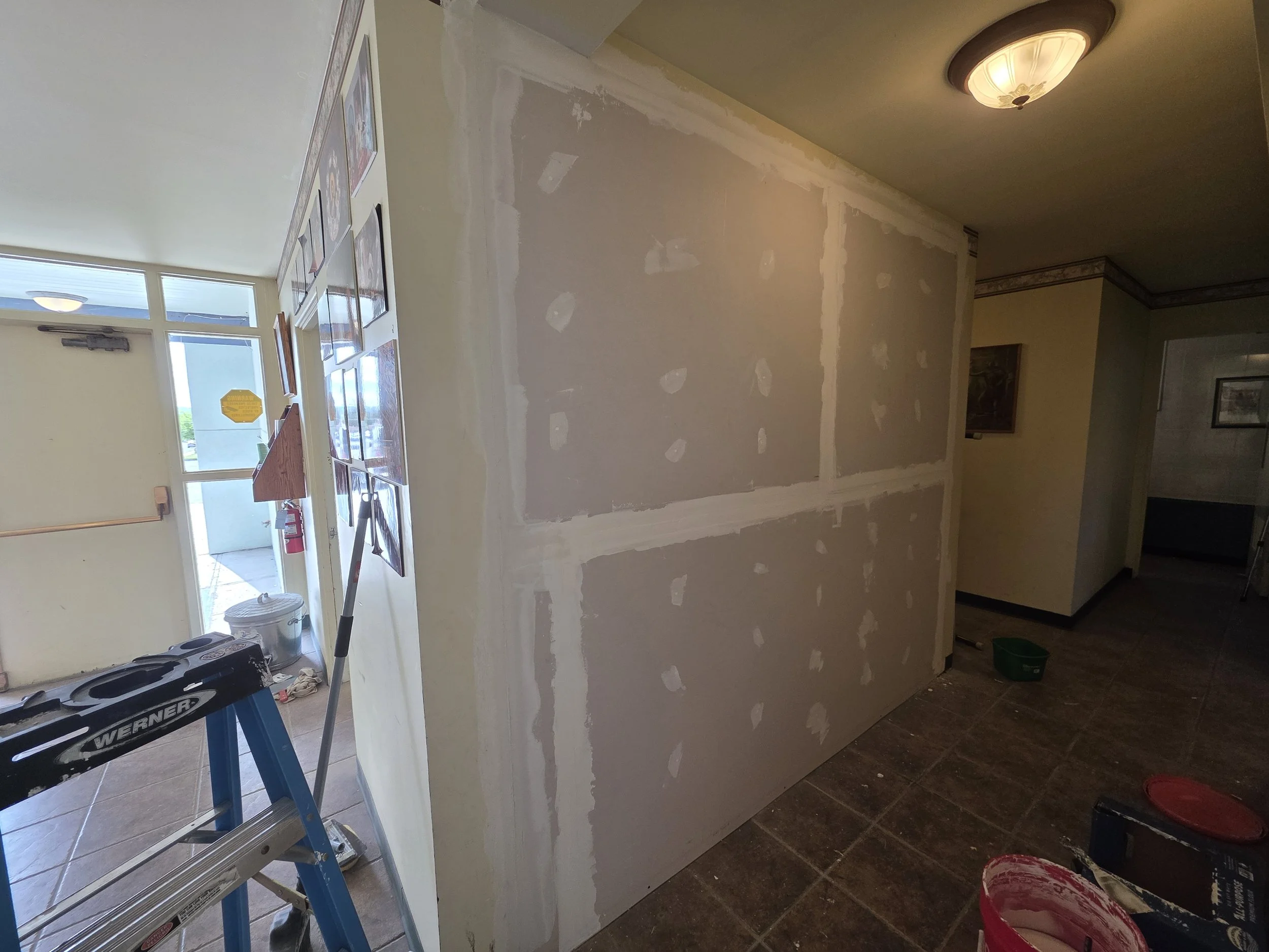 Hallway side of the new wall drywalled and mudded, Butte, Montana