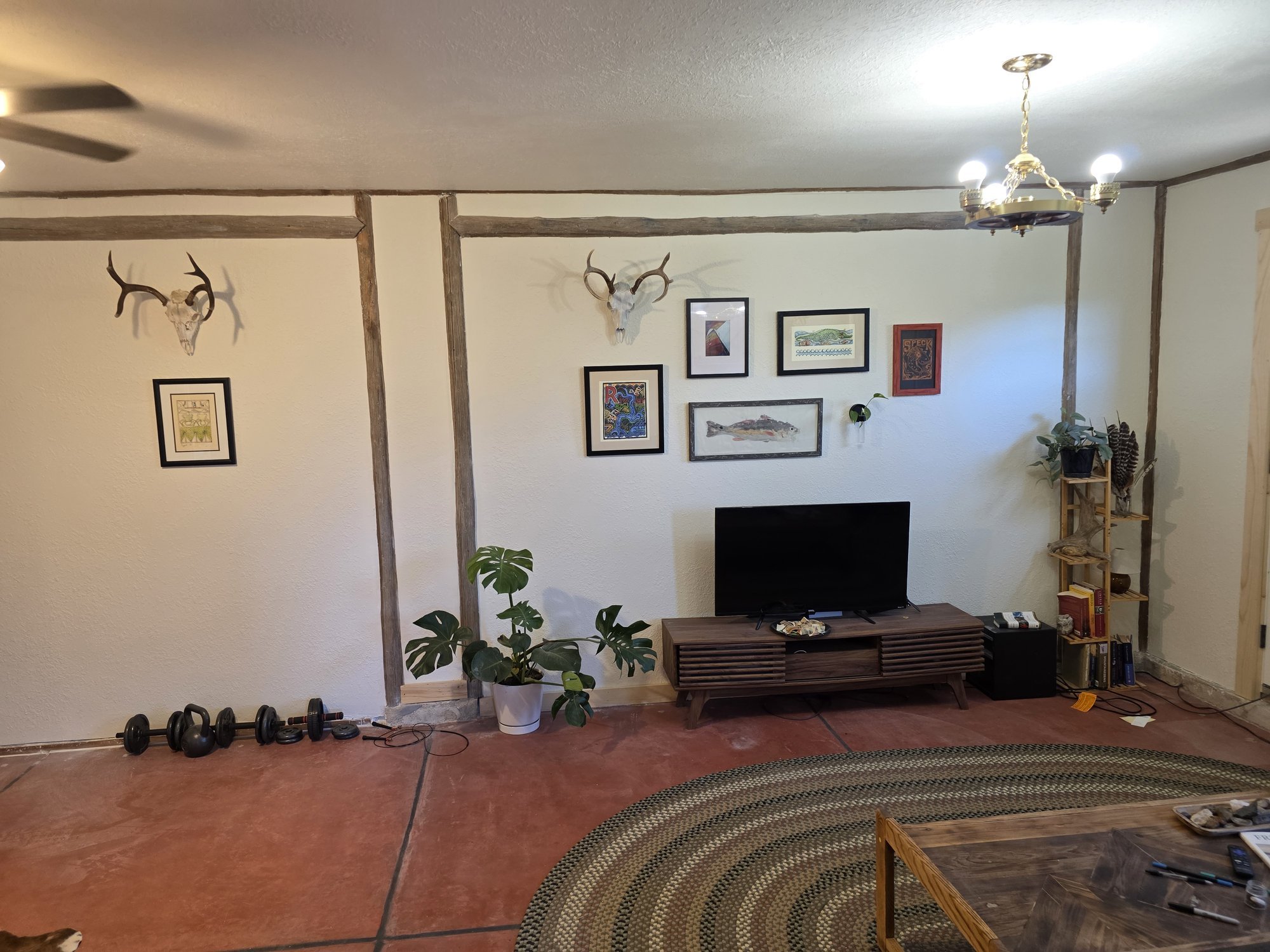 Renovated bunkhouse living room with new drywall, painted trim and exposed beams, Cardwell, MT