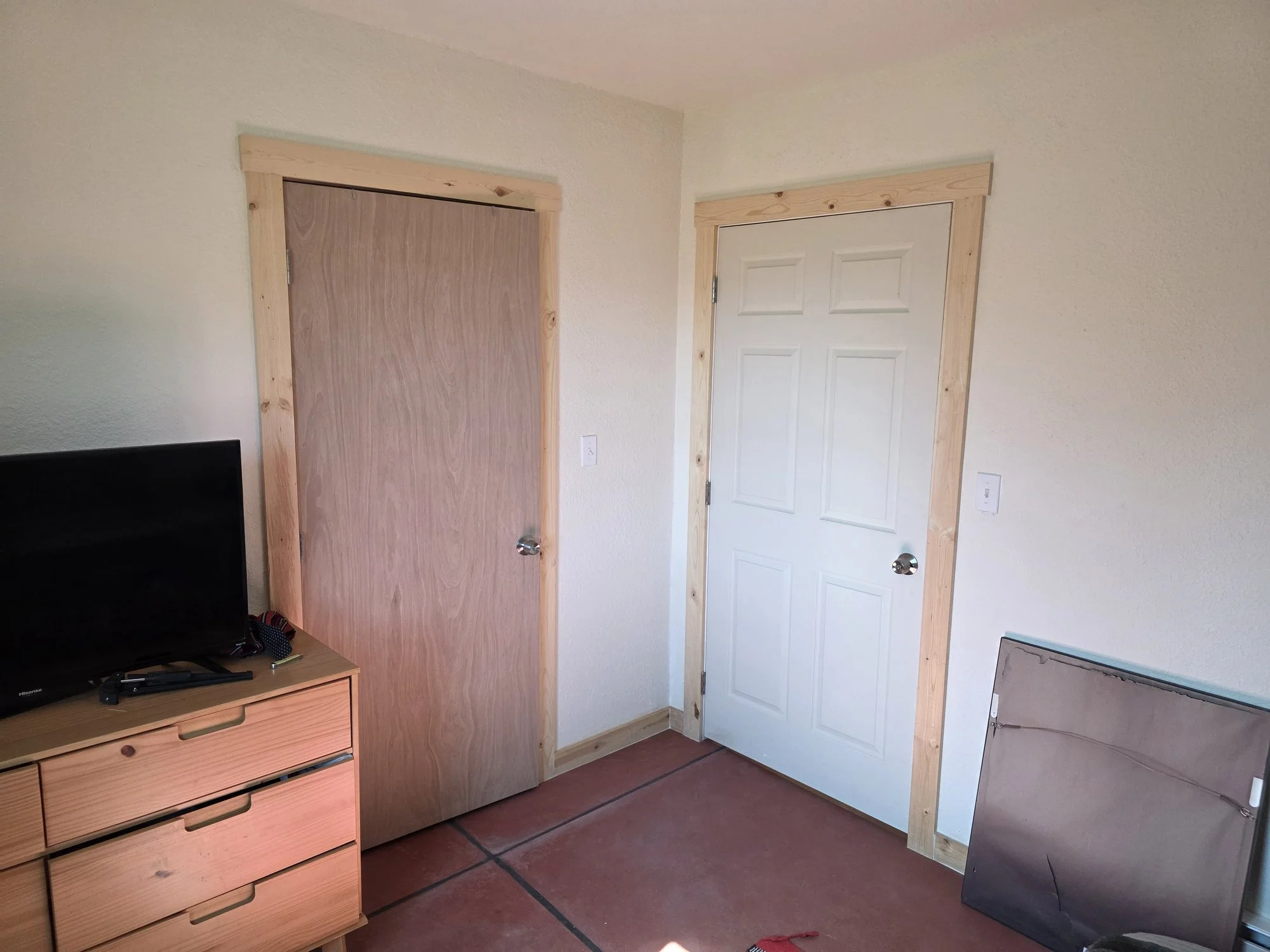 New bedroom and laundry room doors framed out of the open room in a Cardwell, Montana bunkhouse