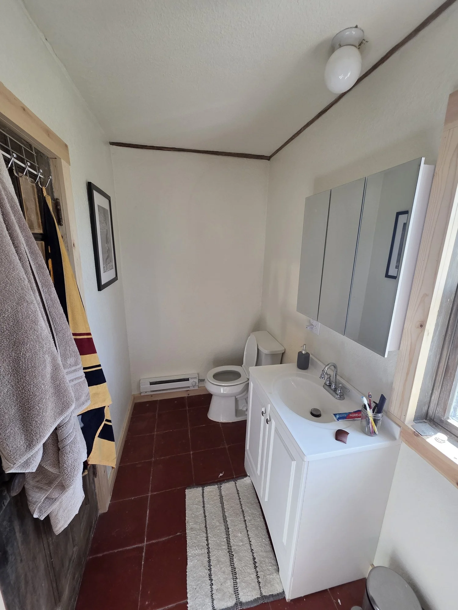 Finished bunkhouse bathroom near Cardwell, Montana with new vanity, trim and paint