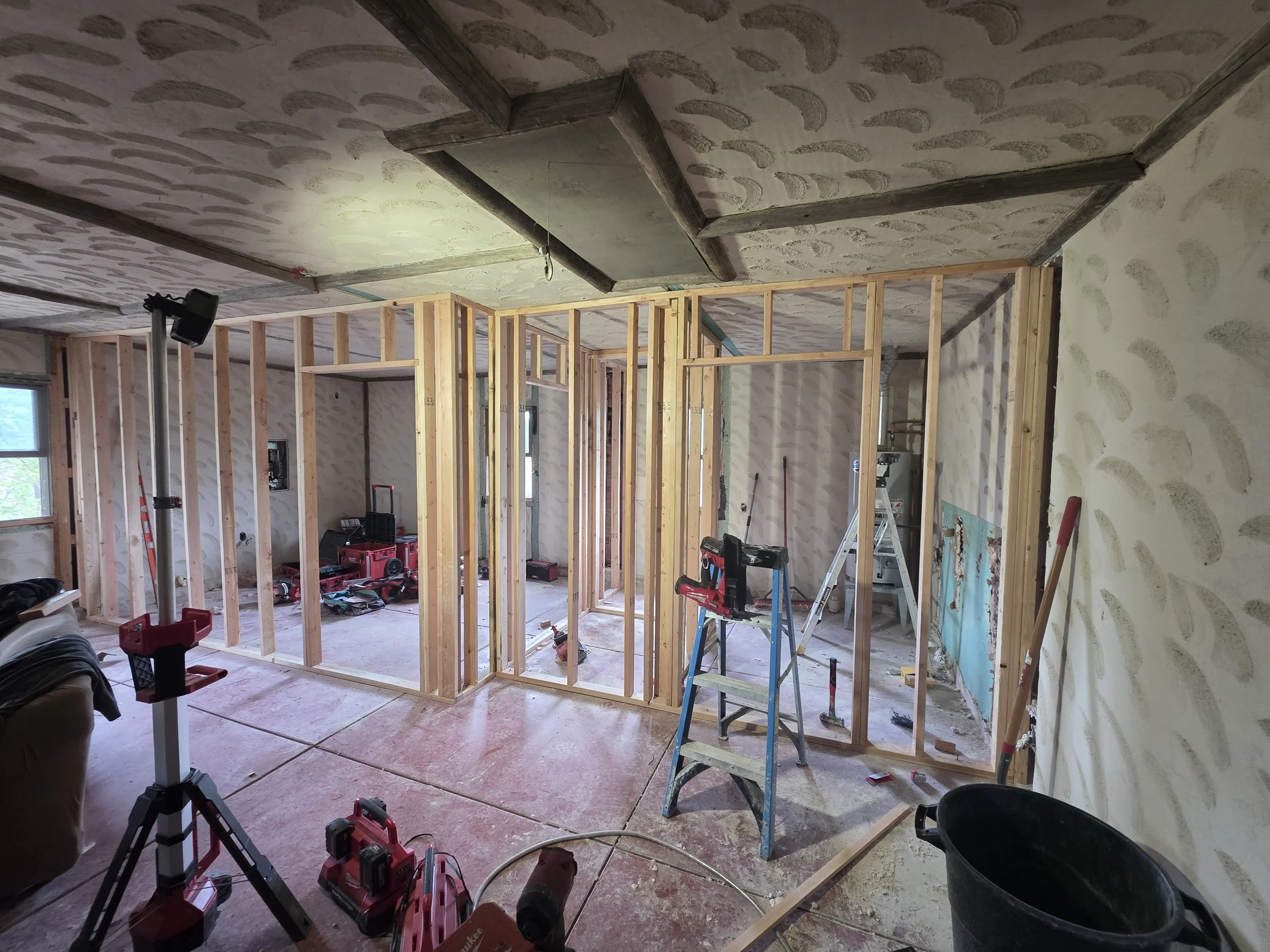 Framing the new bedroom and laundry room walls inside the open bunkhouse, Cardwell, Montana