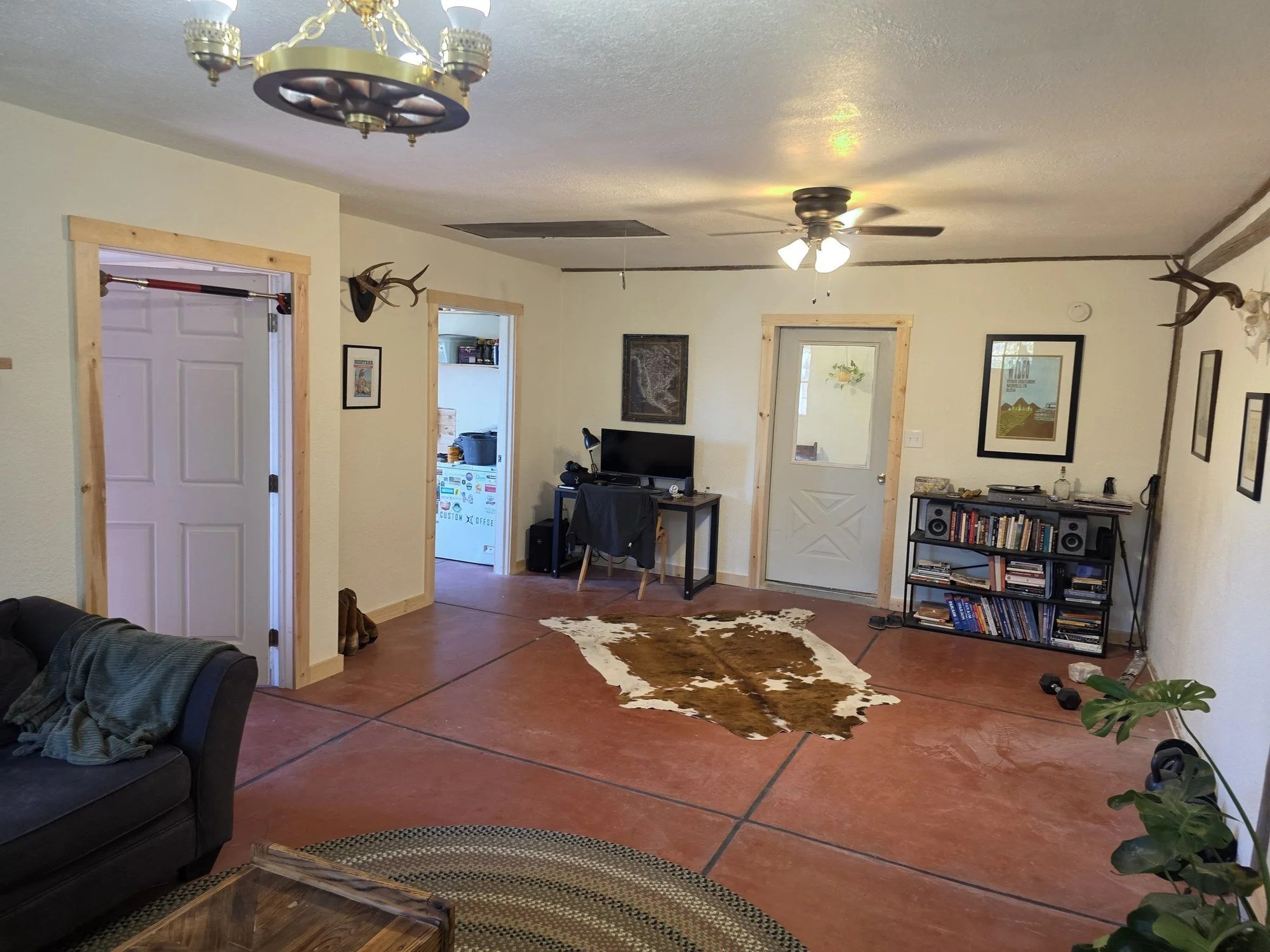 Renovated bunkhouse living room with a stained concrete floor, looking toward the new kitchen, Cardwell, MT