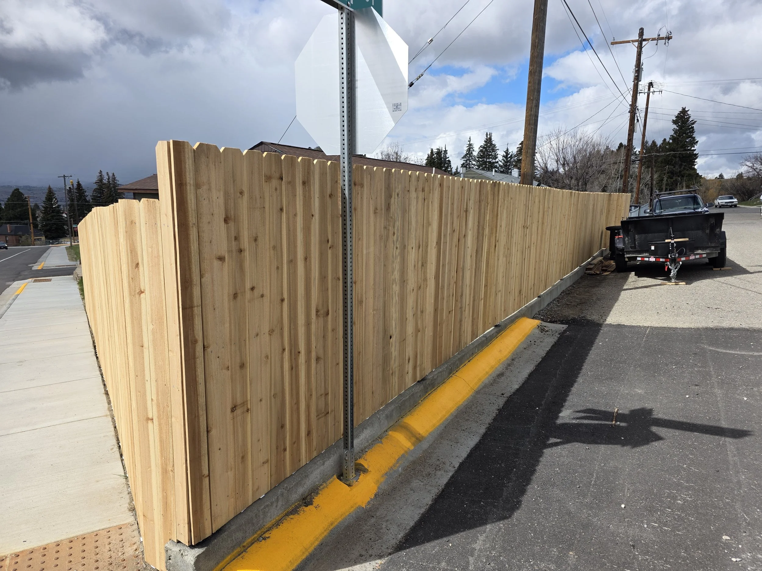 Cedar privacy fence along the sidewalk at the corner of the lot, Walkerville, Montana