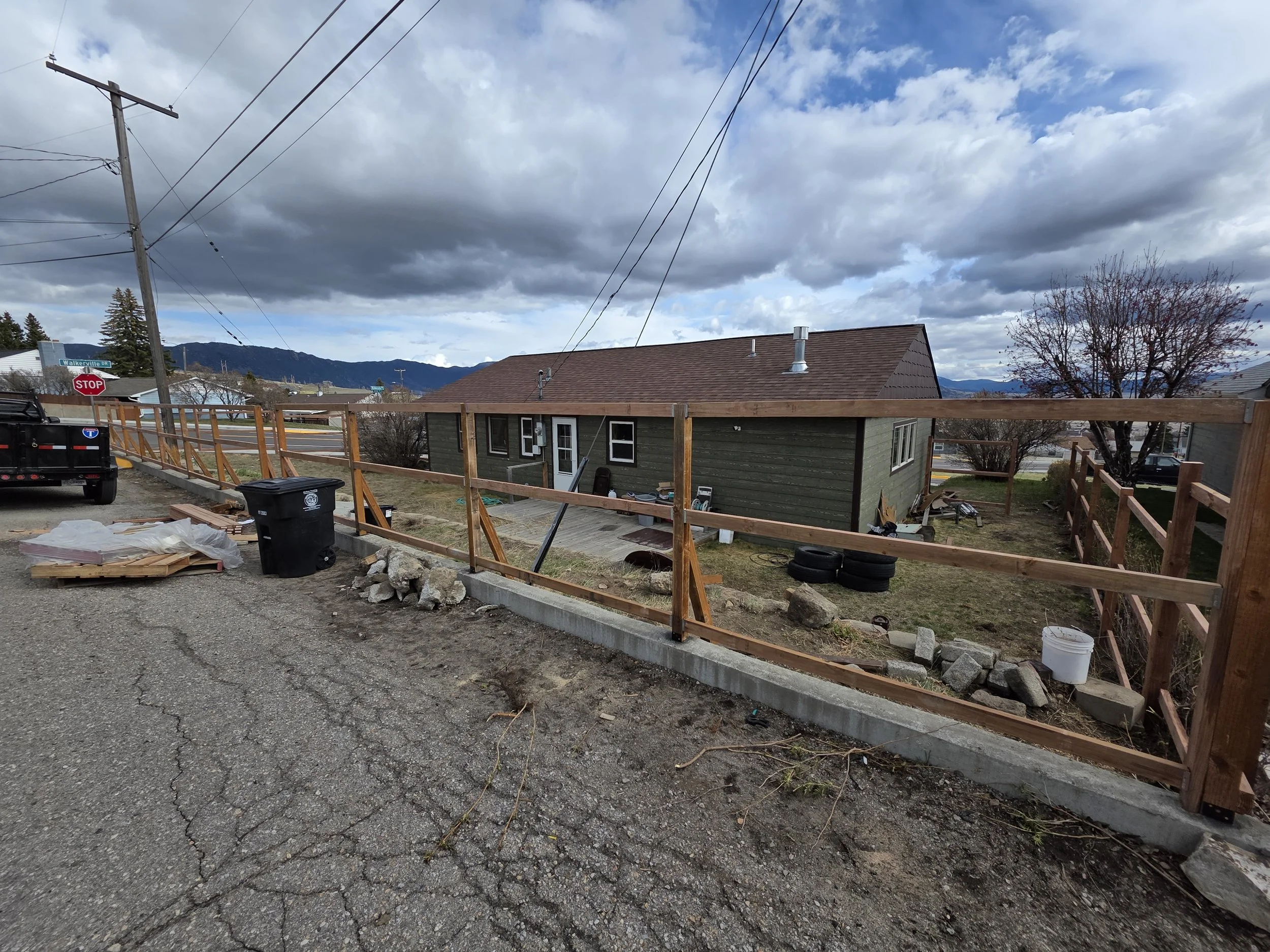 Fence posts and rails up along the street side of a Walkerville, Montana home