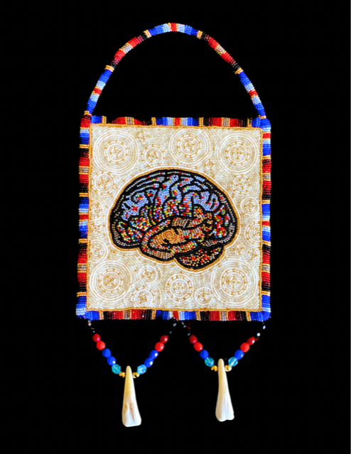 Beaded bag with a brain design embroidered on it, featuring a strap and hanging beads with shells at the end, against a black background.