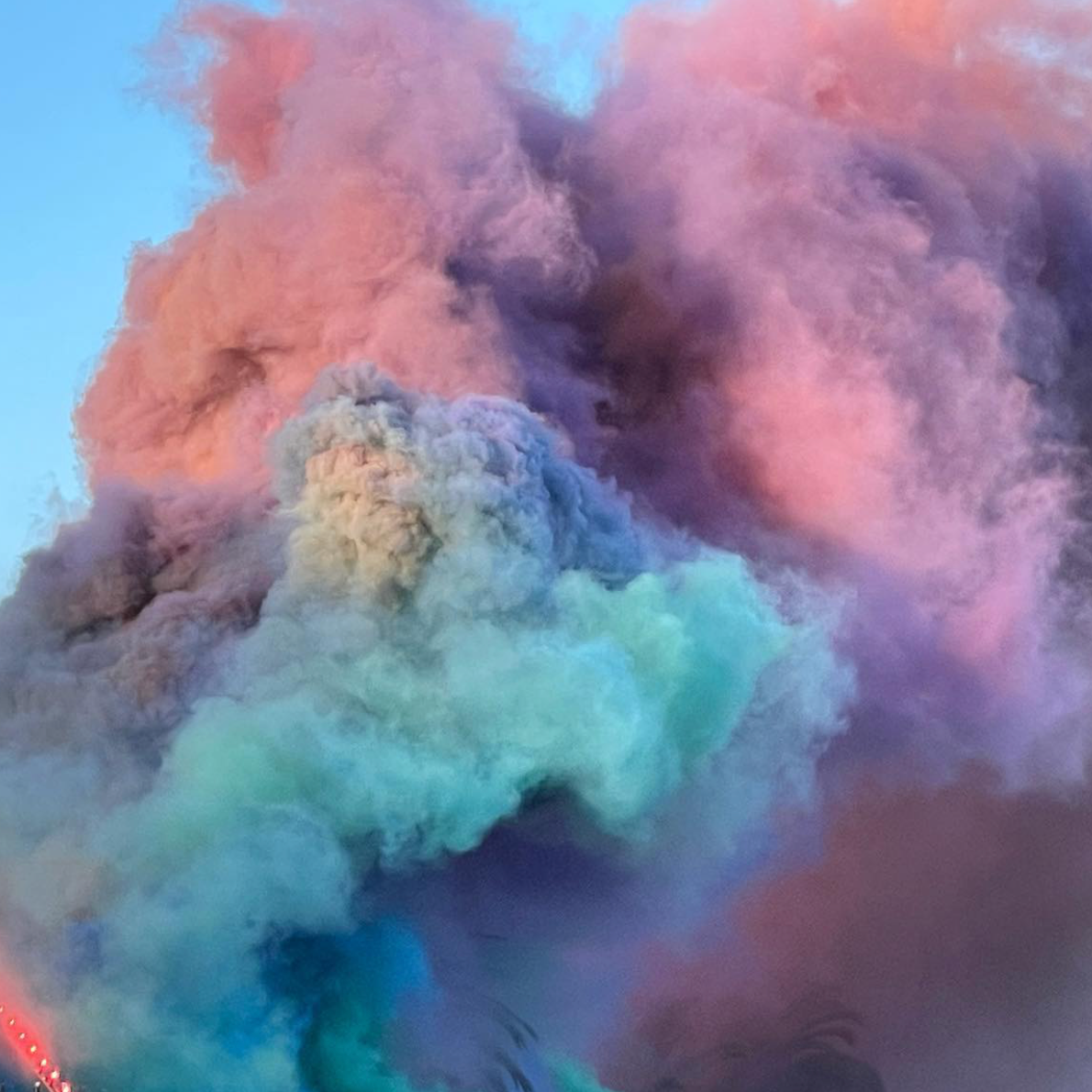Colorful smoke clouds in pink, purple, blue, and teal hues.