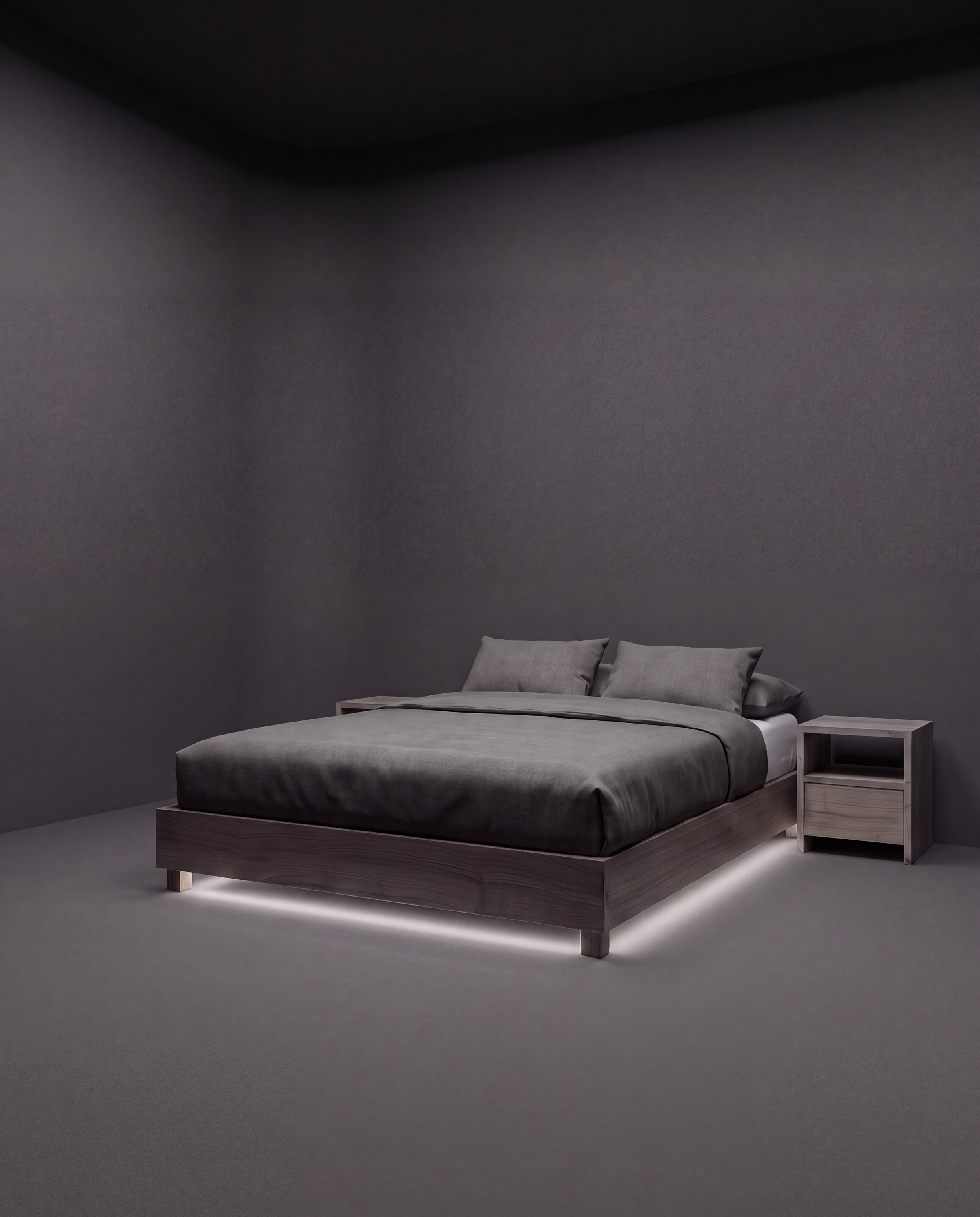 A minimalist bedroom with a modern wooden bed, gray bedding, and two gray pillows. A small wooden nightstand is on the right side of the bed. The walls are dark gray, and there is subtle lighting highlighting the base of the bed.