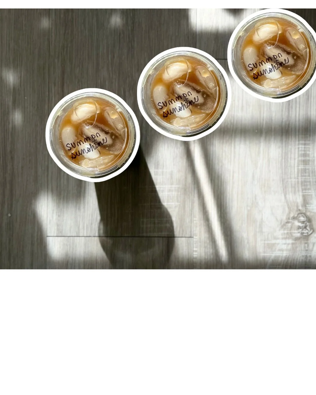 Three iced coffees arranged diagonally on a tabletop.