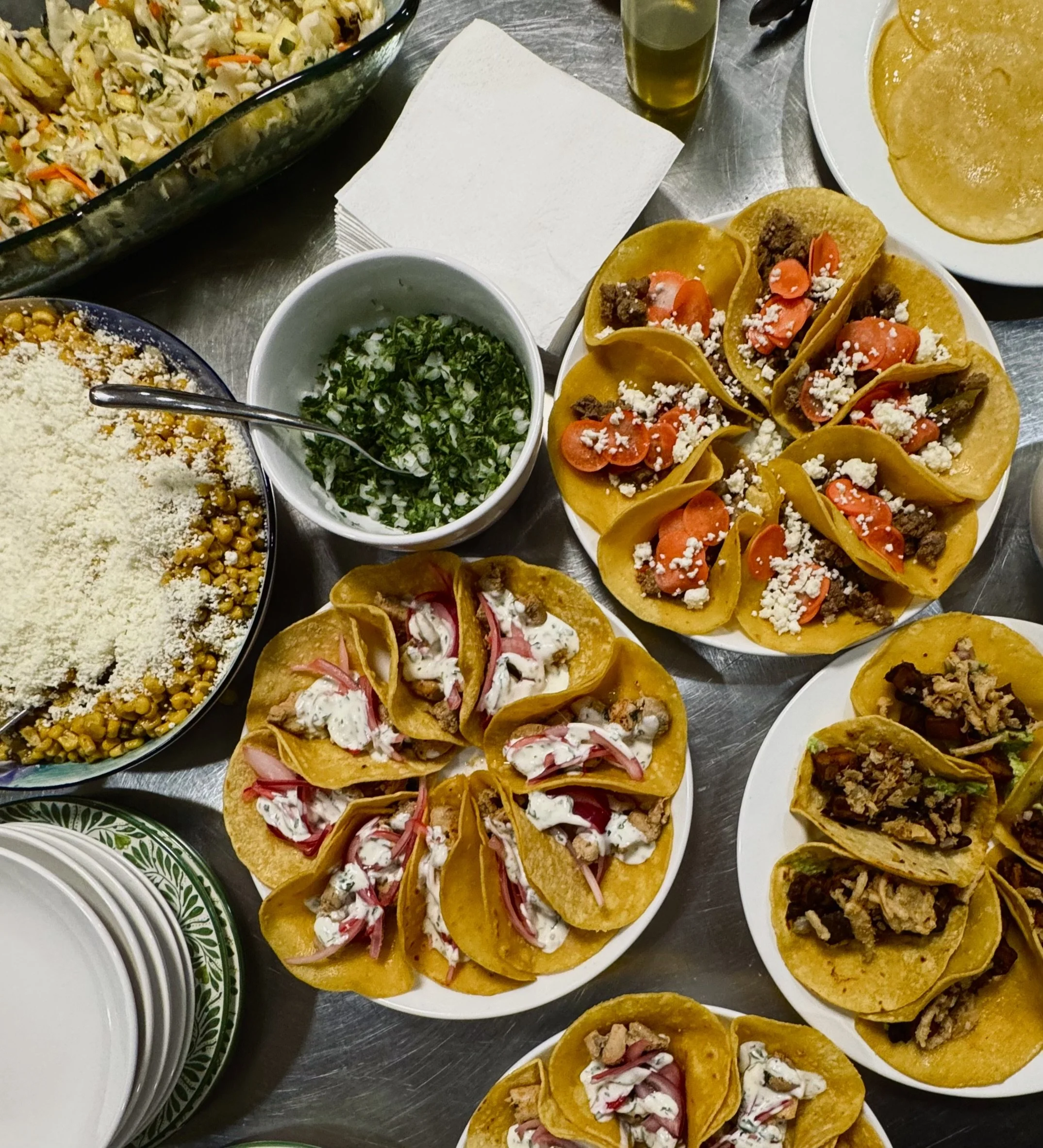 Assorted tacos with colorful toppings, prepared by Chef Dom Every.