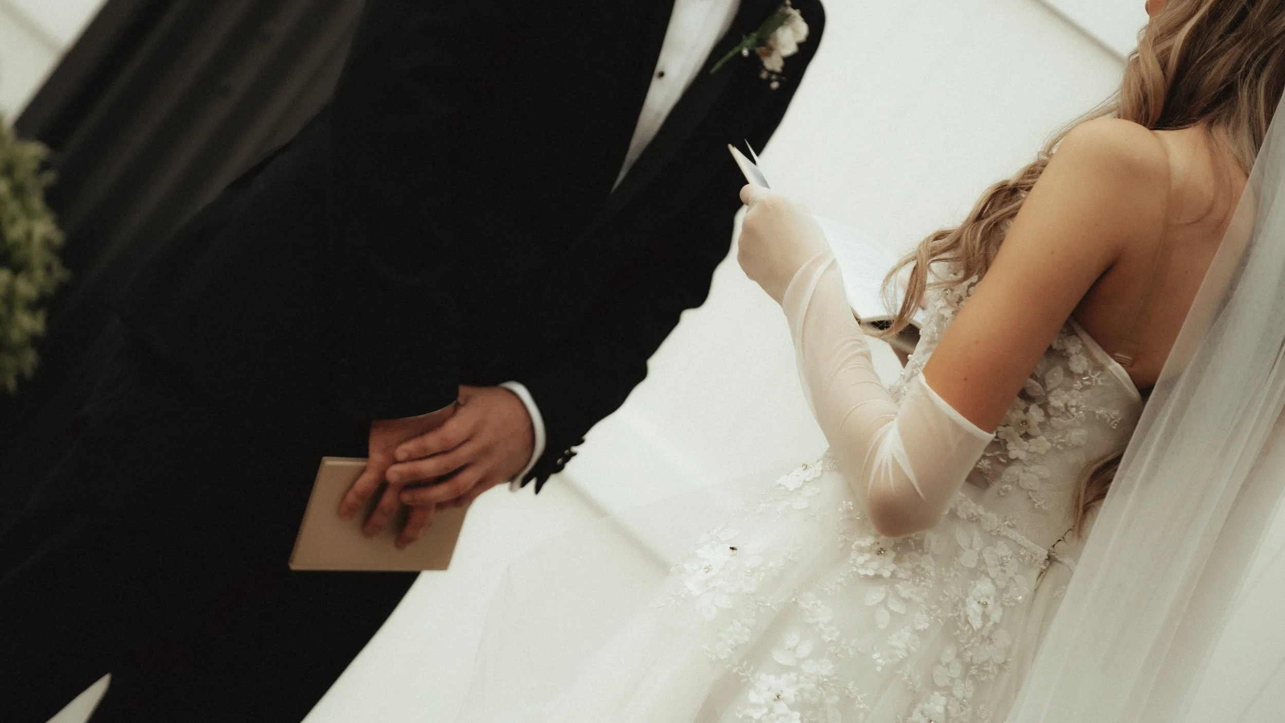 Bride and groom holding hands during their wedding ceremony