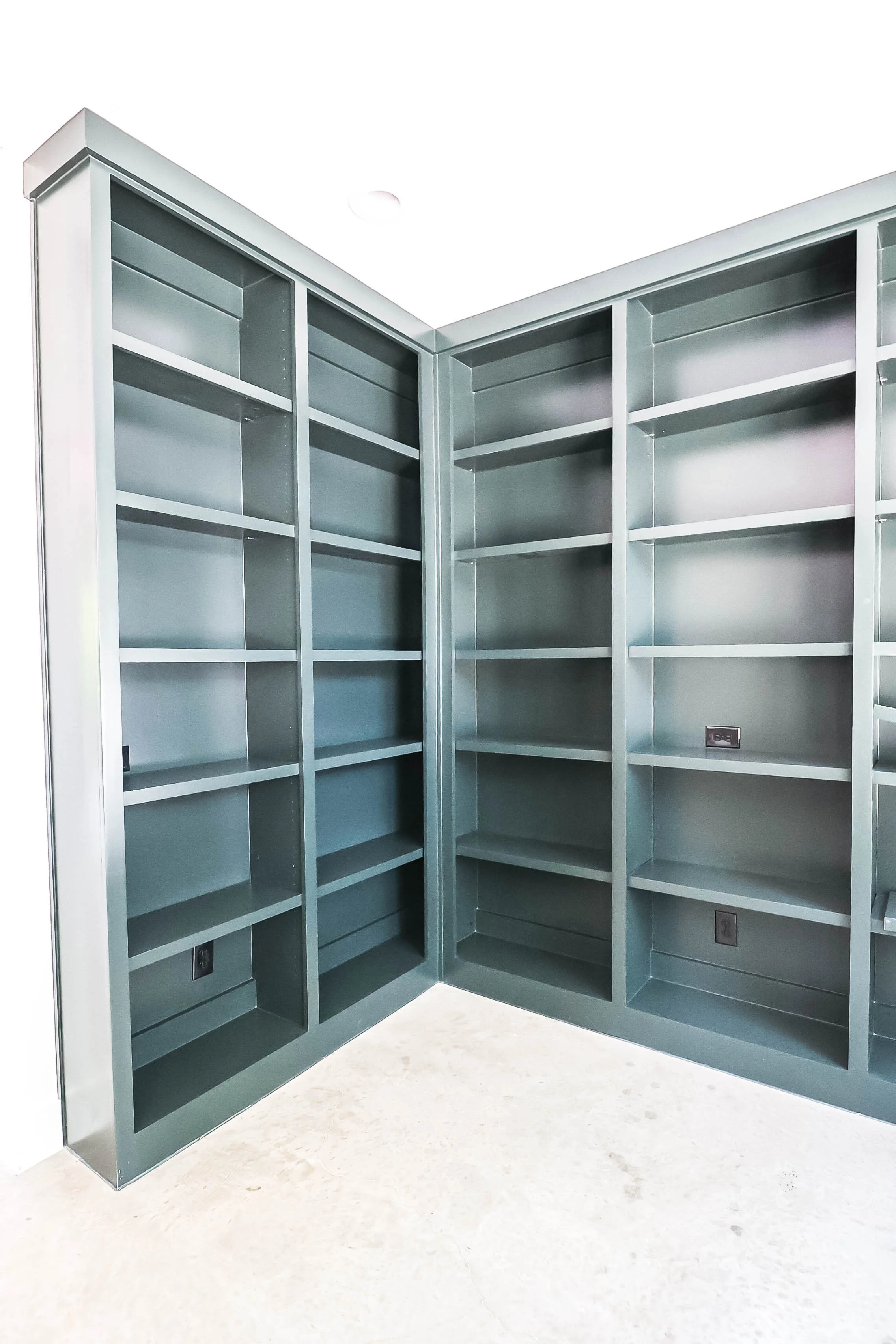 Empty metal bookshelf with multiple shelves in an indoor setting
