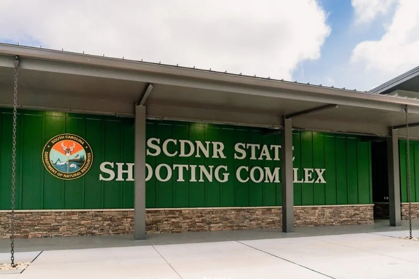 Sign on building reading 'SCDNR State Shooting Complex' with South Carolina Department of Natural Resources logo.