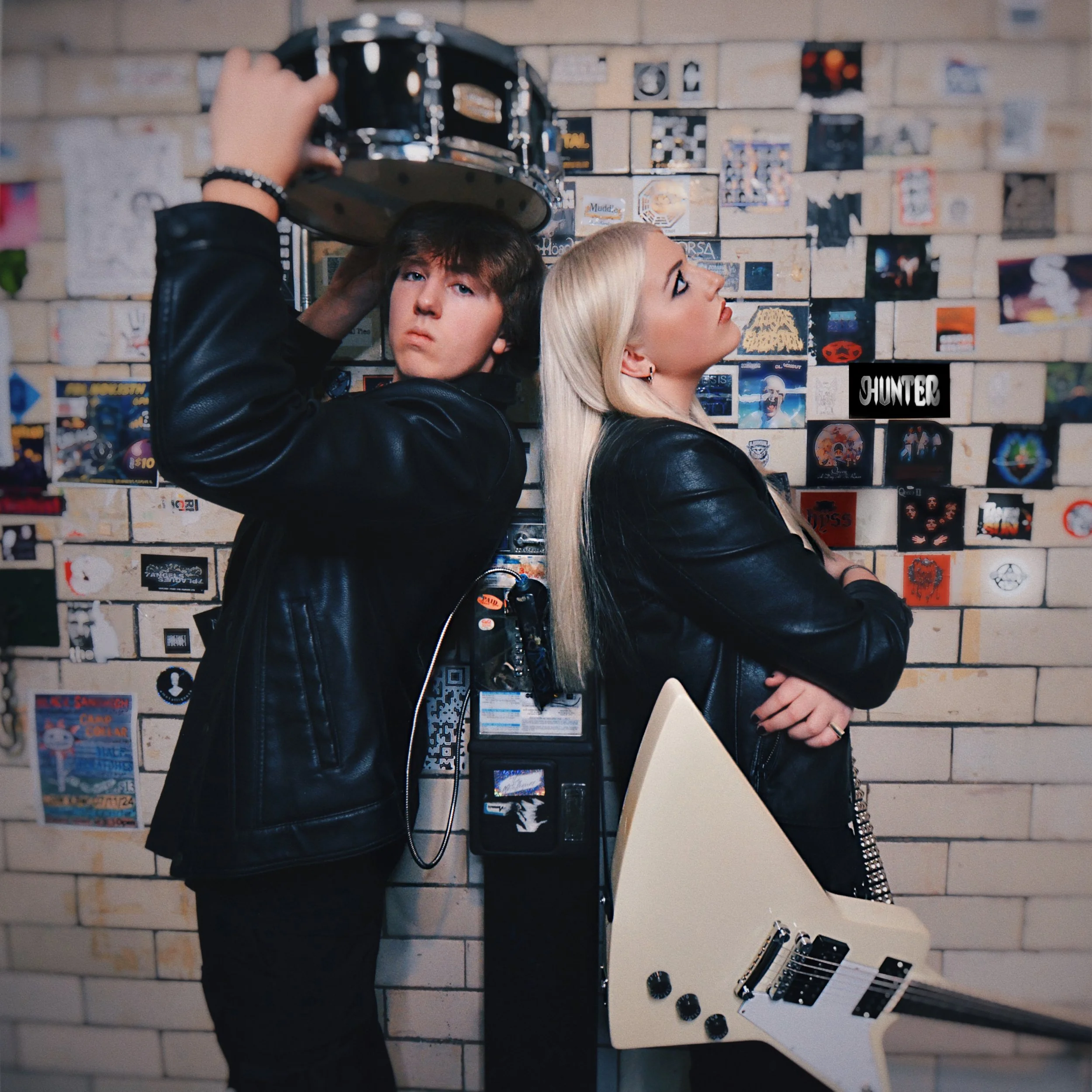 The Superock HUNTER EP Cover Art, featuring Lauren Hunter and Chase Hunter standing back to back with their guitar and drum.