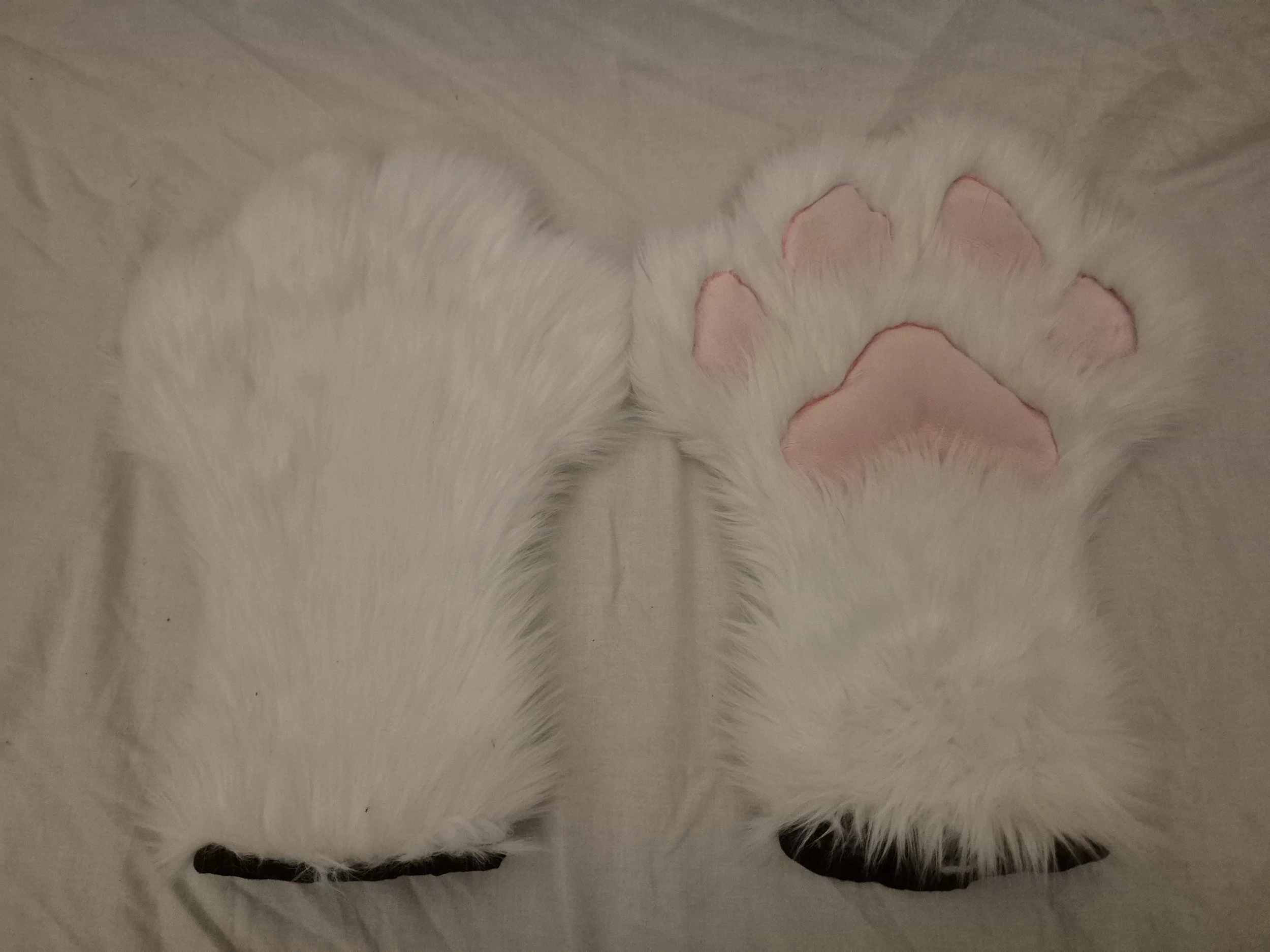 Skimble's handpaws, fully lined with squishy, minky paw pads.