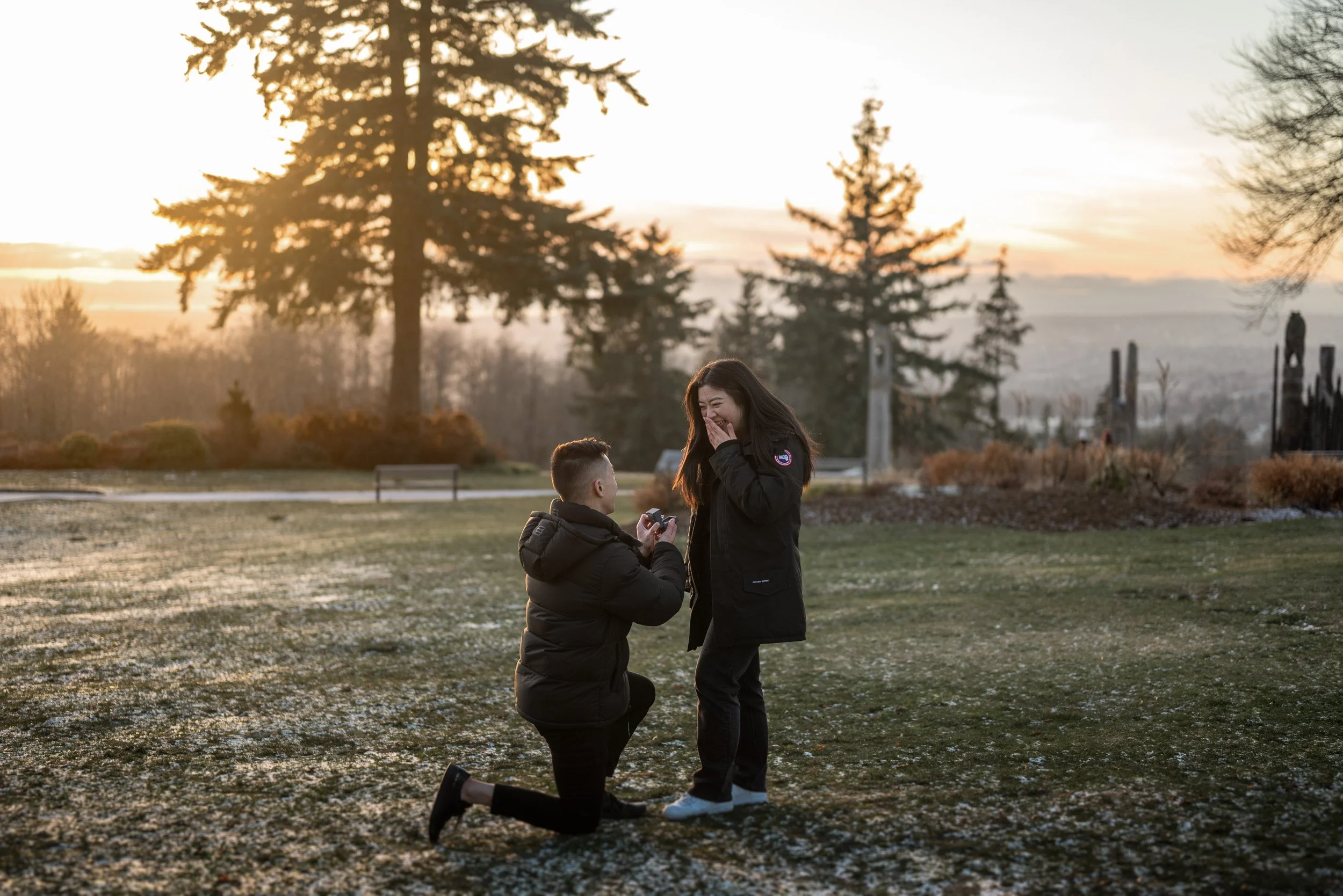 A young man proposing to a young girl at Burnaby Mountain, BC, at sunset. This is a sunset proposal at Burnaby mountain.