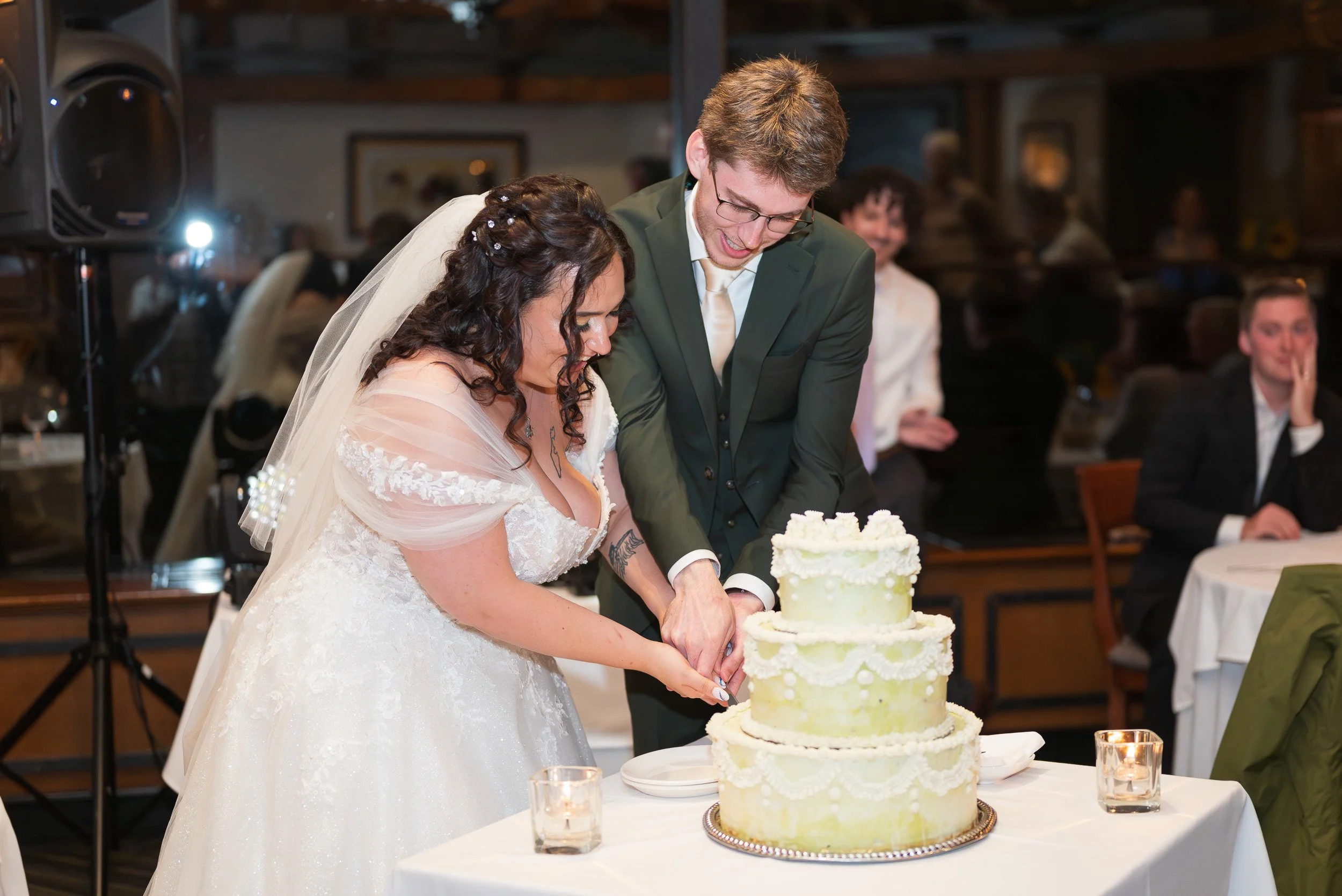 Bride and groom cutting wedding cake at their wedding reception at Season in Park in Vancouver