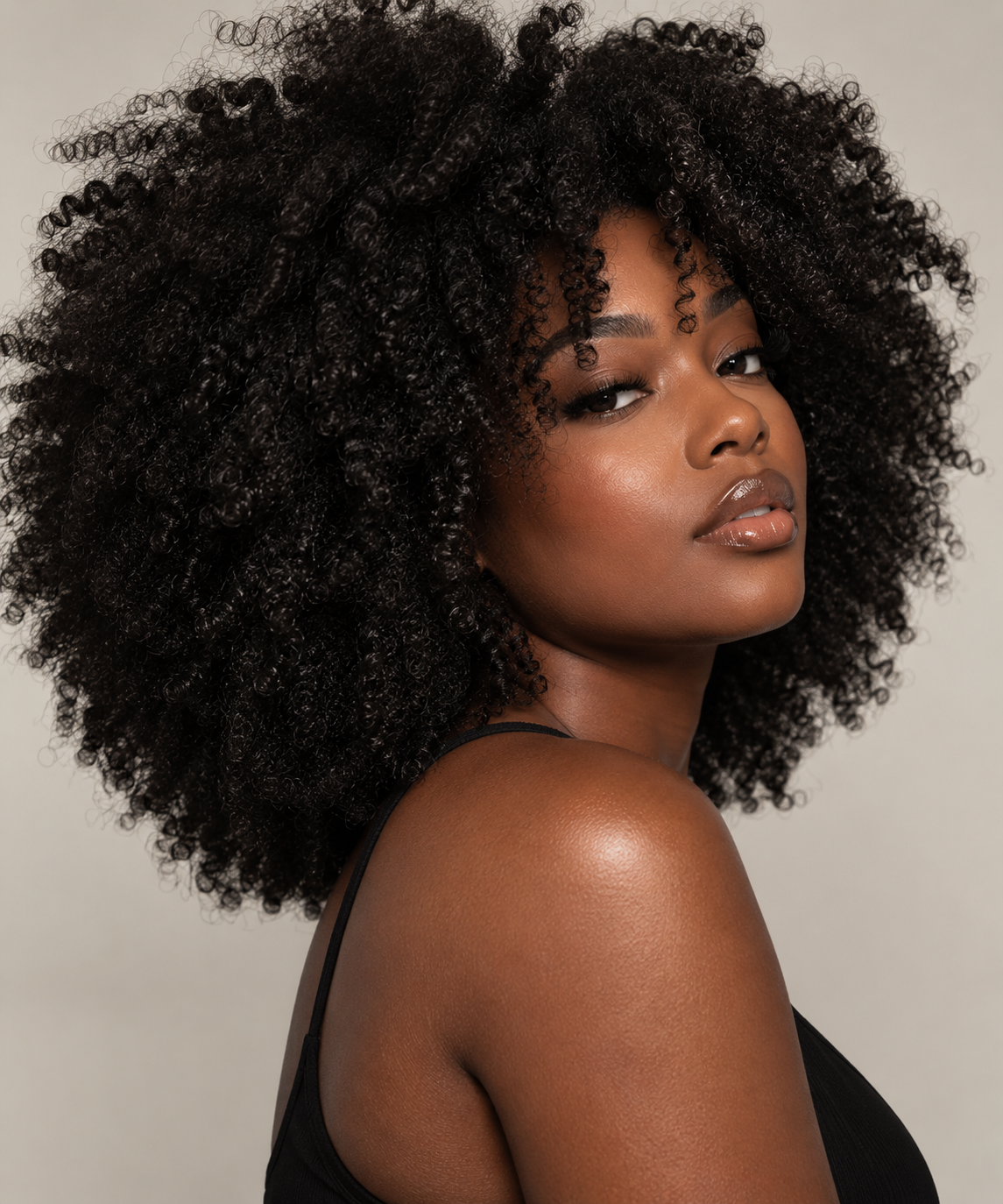Black woman with natural 4C hair in an editorial beauty portrait for SK PARLOR.