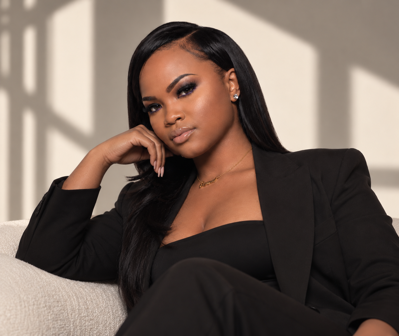 Sarah Kelly, founder of SK PARLOR, seated in an editorial beauty portrait wearing a black blazer.