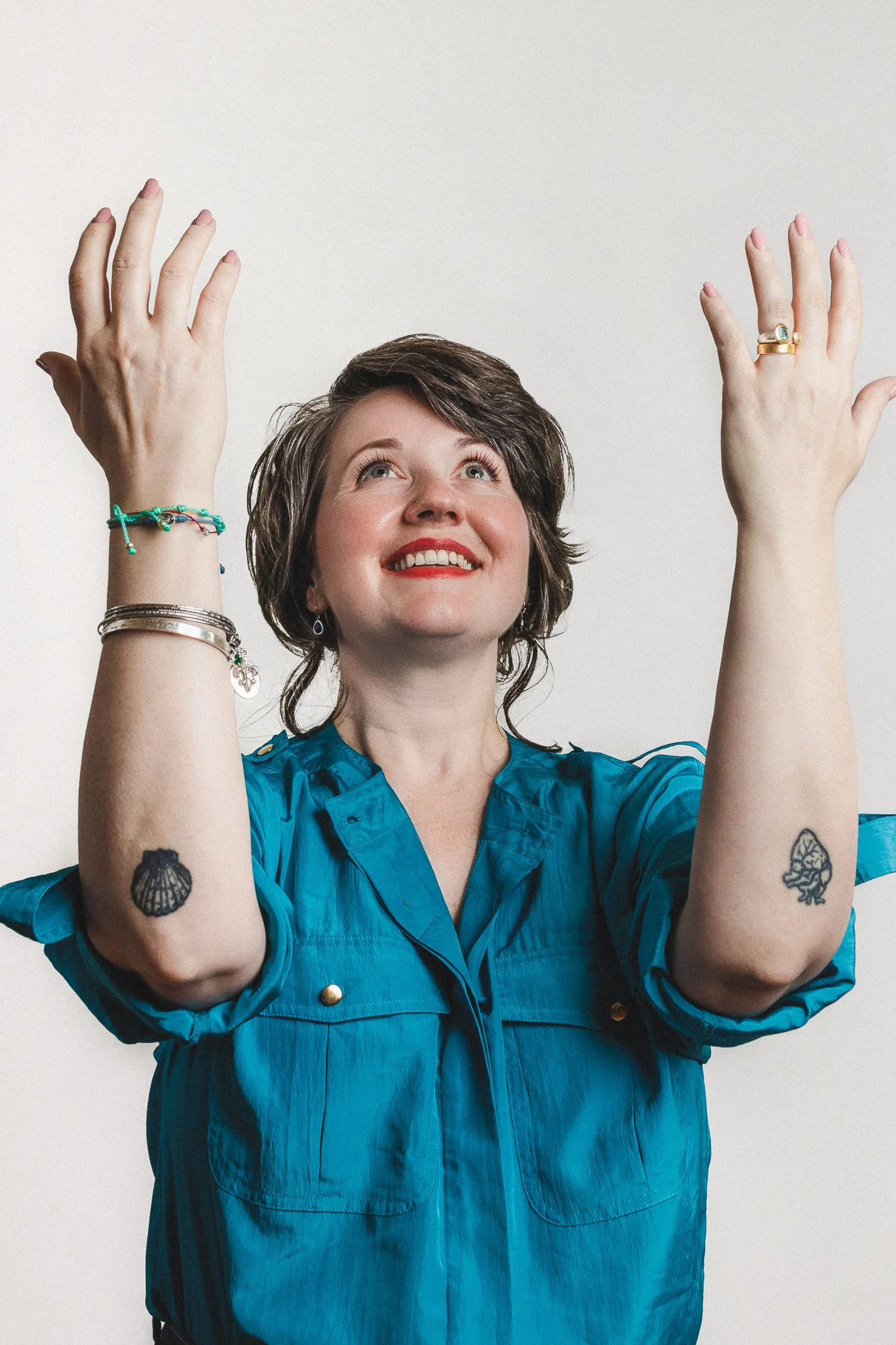 Rev. Bunny Love-Schock standing with her arms and eyes to the sky