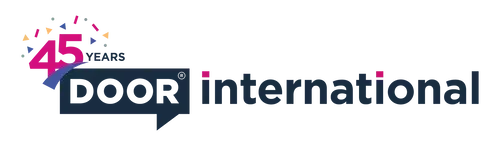 A company logo with 'DOOR' text stylised inside a navy blue angular speech bubble and the ‘International' text to its right in navy with pink dots for the 'i's. A pink '45' and navy 'years' text with colourful confetti on top of the DOOR logo.