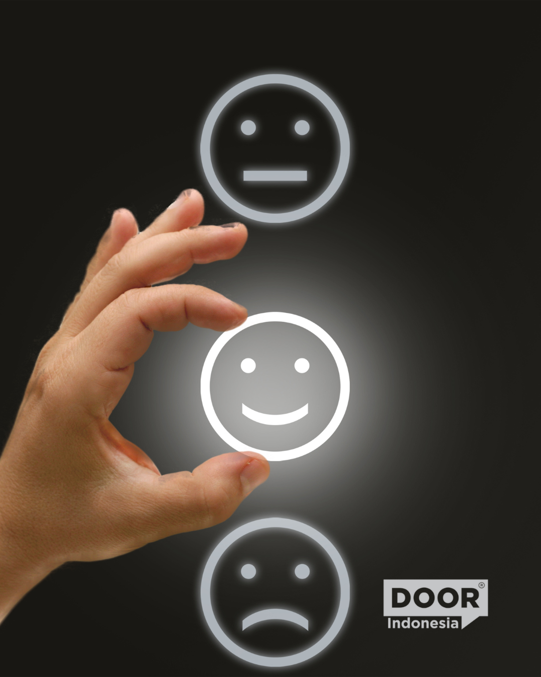 a hand holding a glowing smiley placed in-between a neutral face at the top and a frowning face at the bottom. A DOOR Indonesia logo sits at the bottom right corner