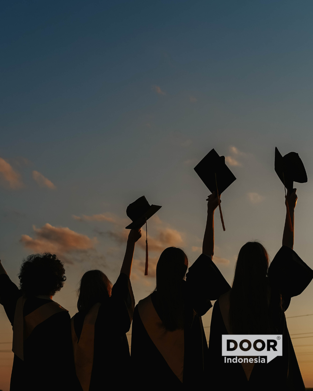 A silhouette of four graduates in graduation toga raising their hats against a sunset sky. DOOR Indonesia logo on the bottom right corner.