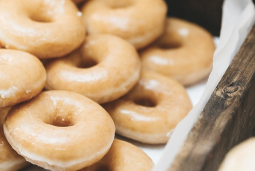 A close-up of glazed donuts in a wooden basket. Garden Wedding venue Atlanta Georgia The Wildflower 301