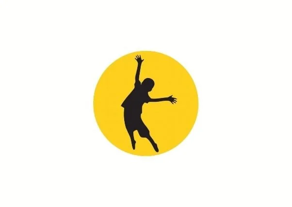Black basketball player silhouette reaching toward a yellow basketball