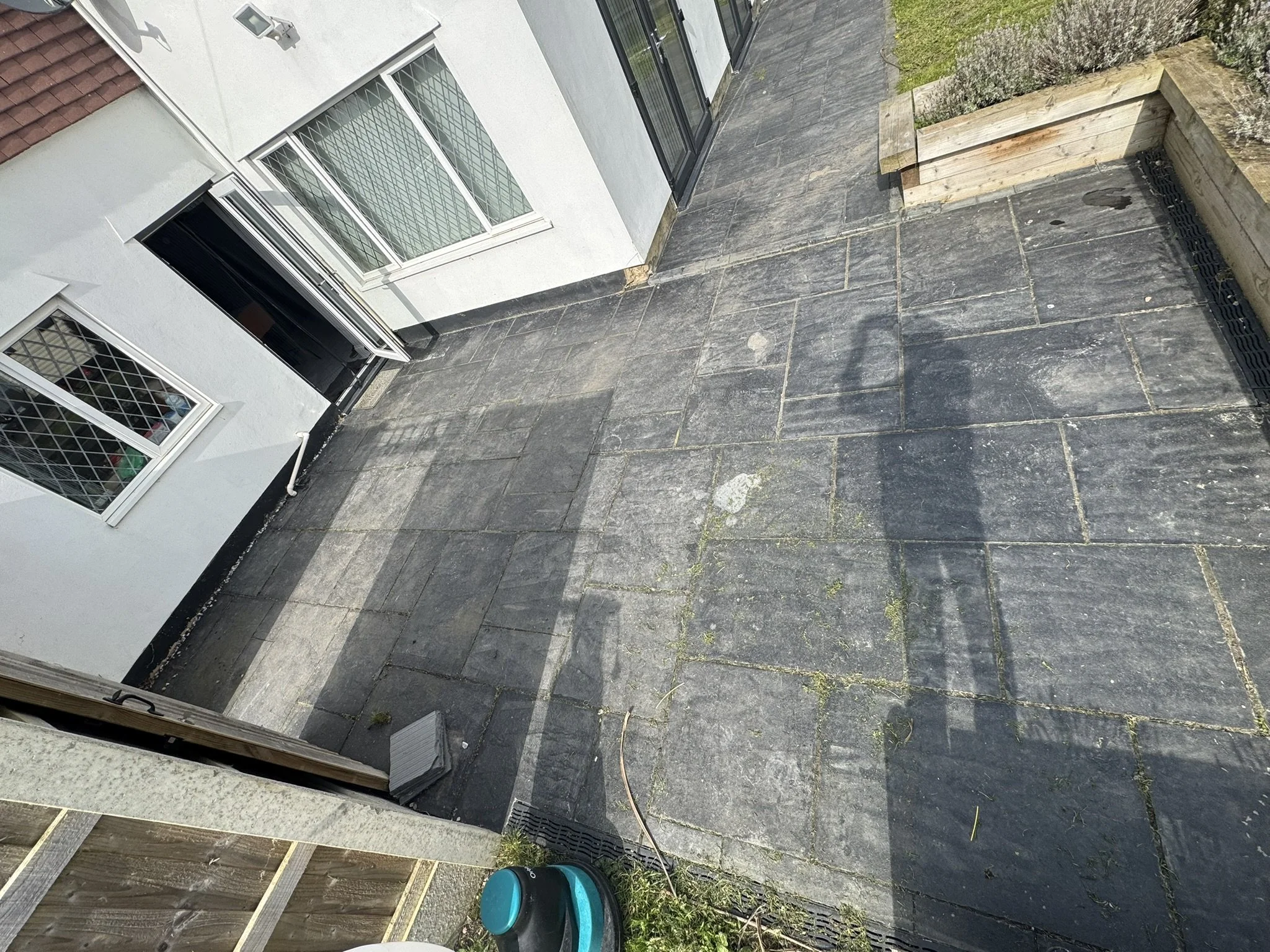 Weathered exterior slate patio before professional deep cleaning, sealer removal and natural stone resealing.