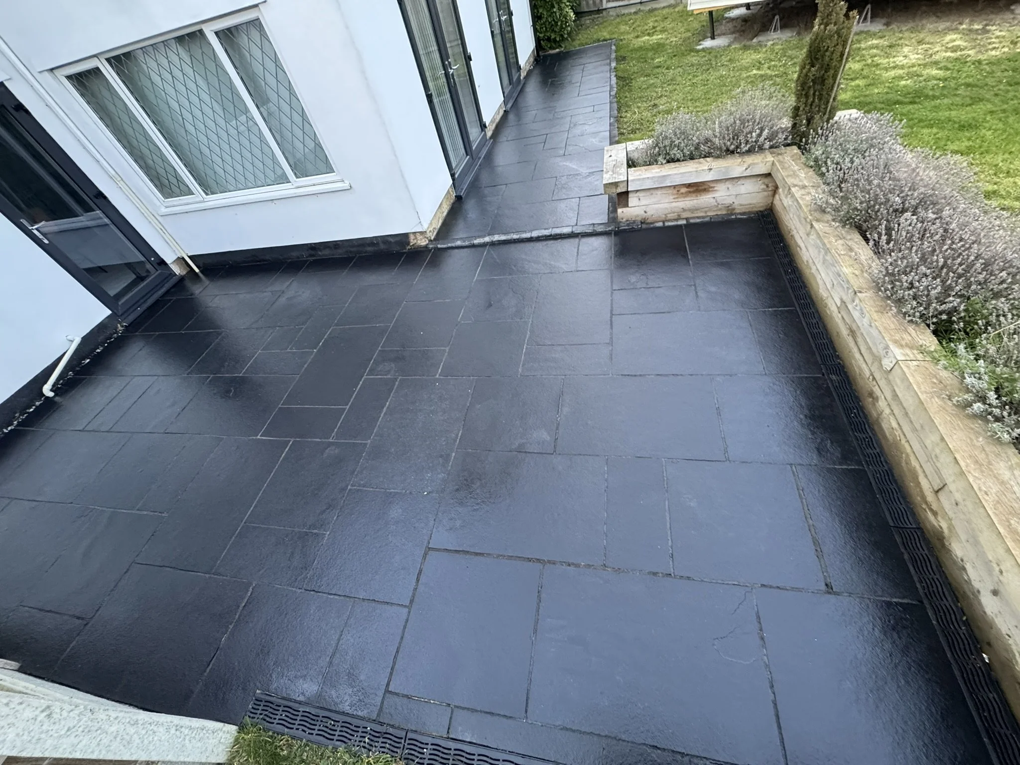 Exterior slate patio after professional deep cleaning and resealing, showing restored colour, a more even finish and renewed stone protection.
