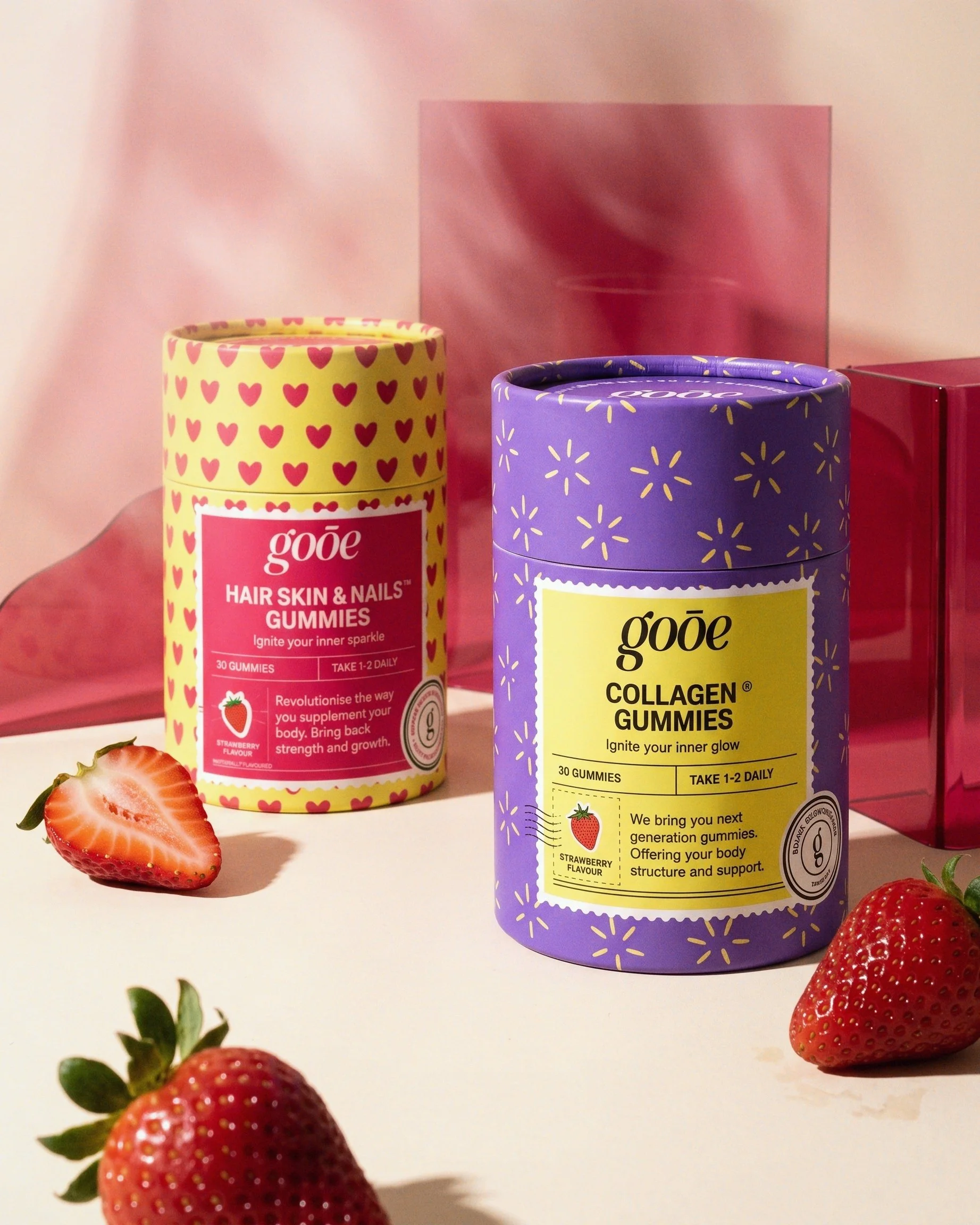 GOOE Hair Skin and Nails Gummies and Collagen Gummies photographed with fresh strawberries