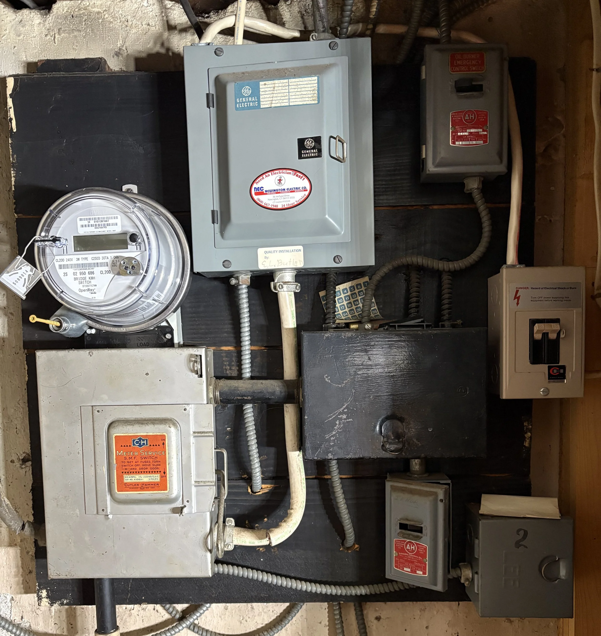 A mess of breakers and fuses all interconnected, old and worn out ready to be replaced with a new square d panel with surge, lightning, AFCI, and GFCI Protection