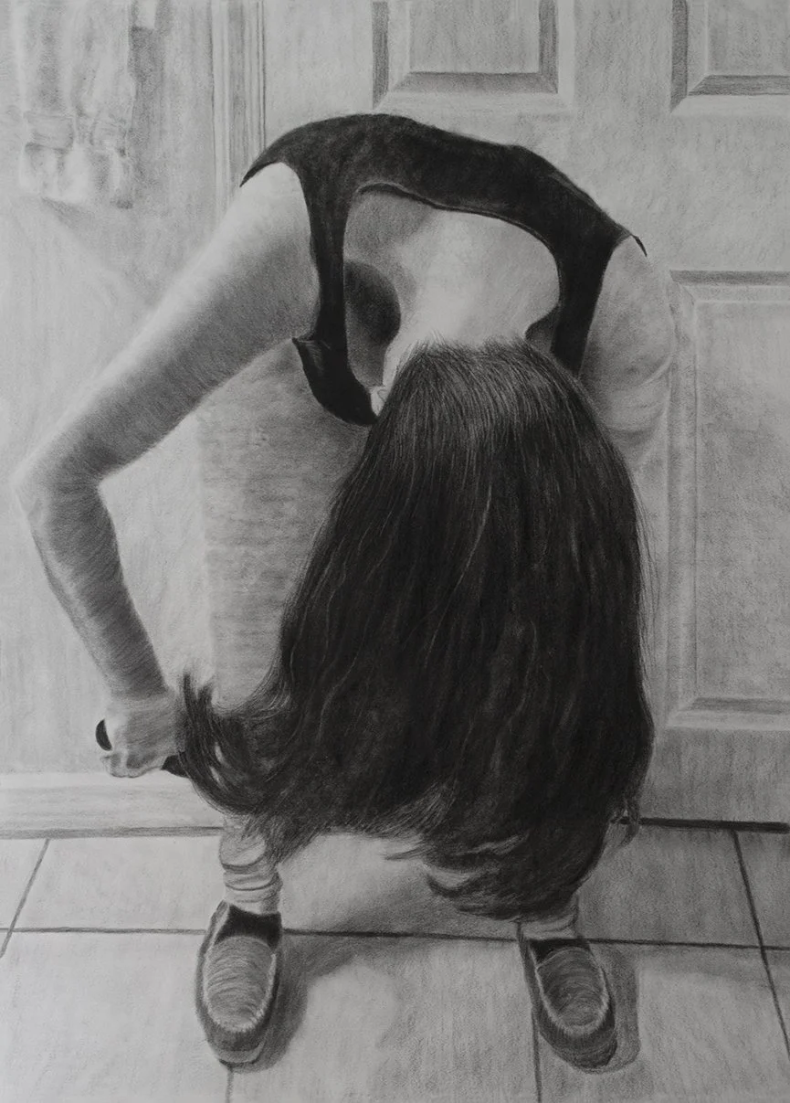 Charcoal drawing of woman bending over her front and brushing her hair