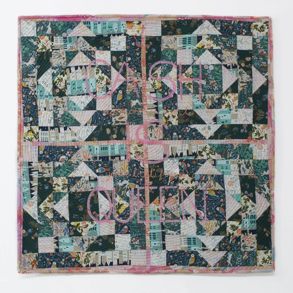 Square green and pink quilt with the words "CASH IS QUEEN" in the center