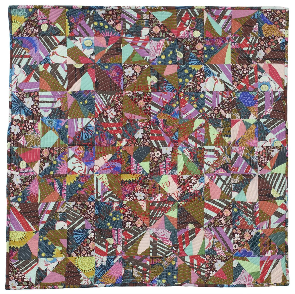 Square quilt in warm red and brown tones with red text spiraling around the center