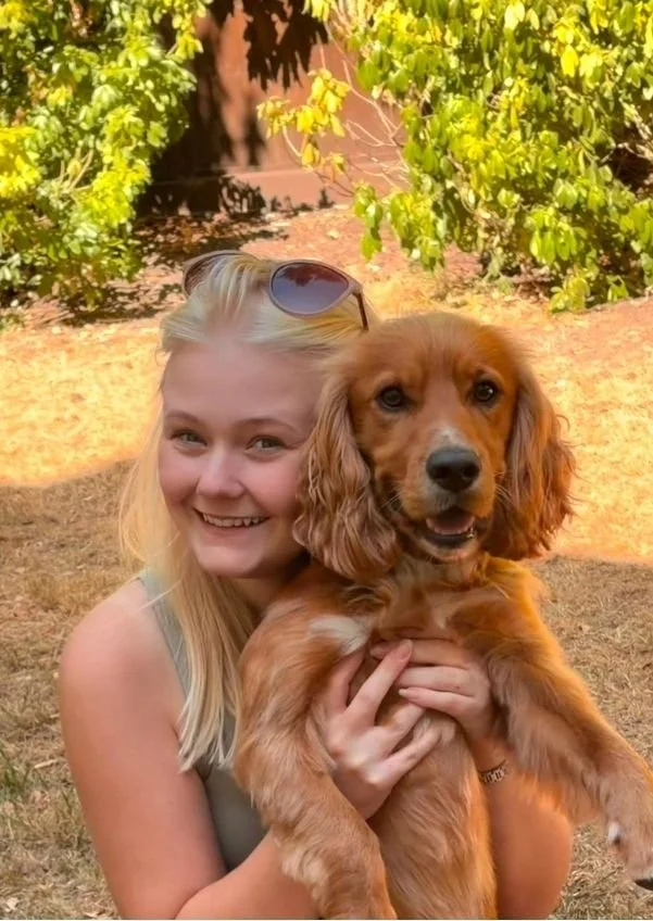 Charlie with Wesley, the Cocker Spaniel behind Wesley & Friends Pet Care.