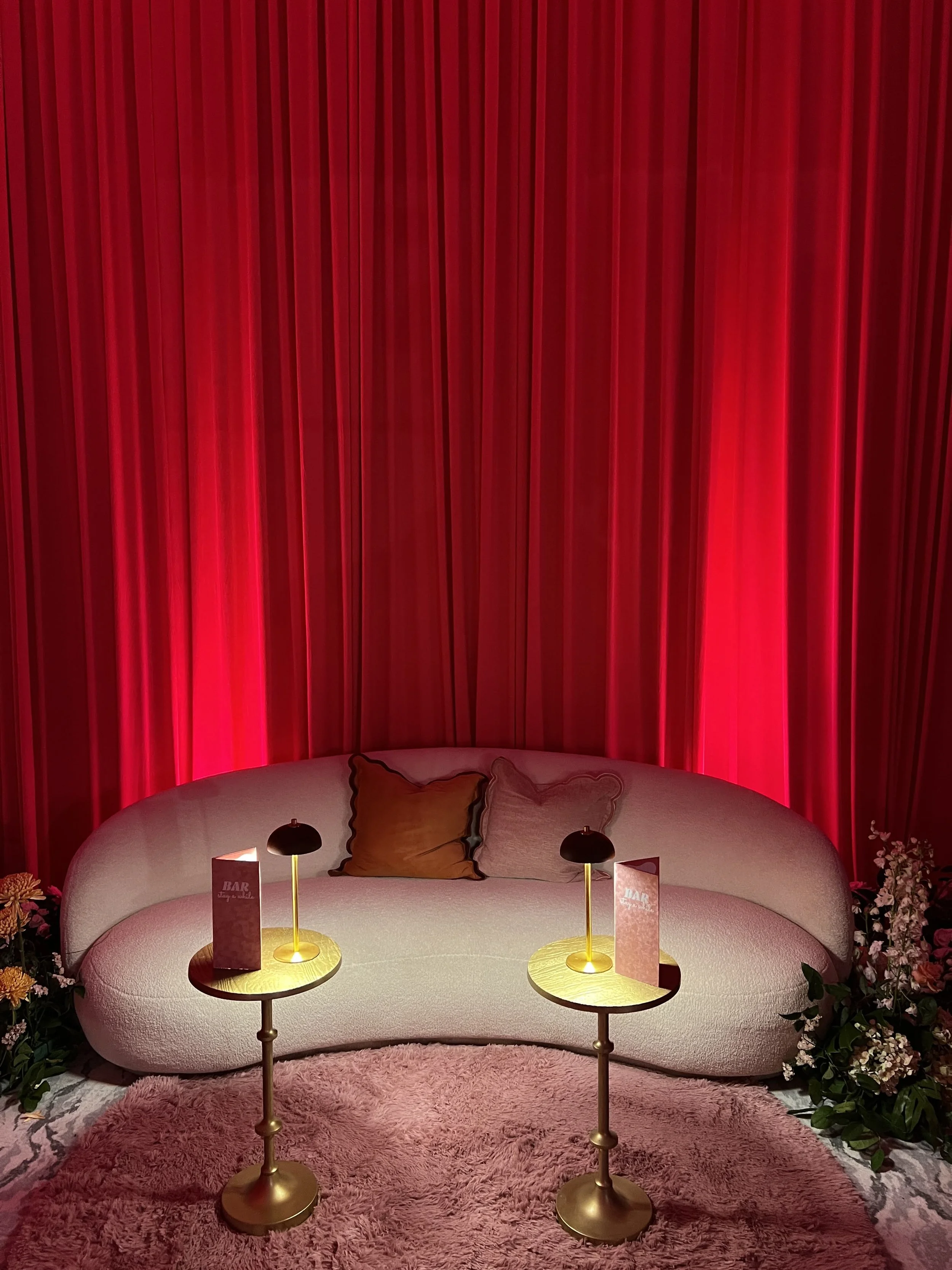 Red curtain lounge seating area with ambient lighting in Southwest Florida