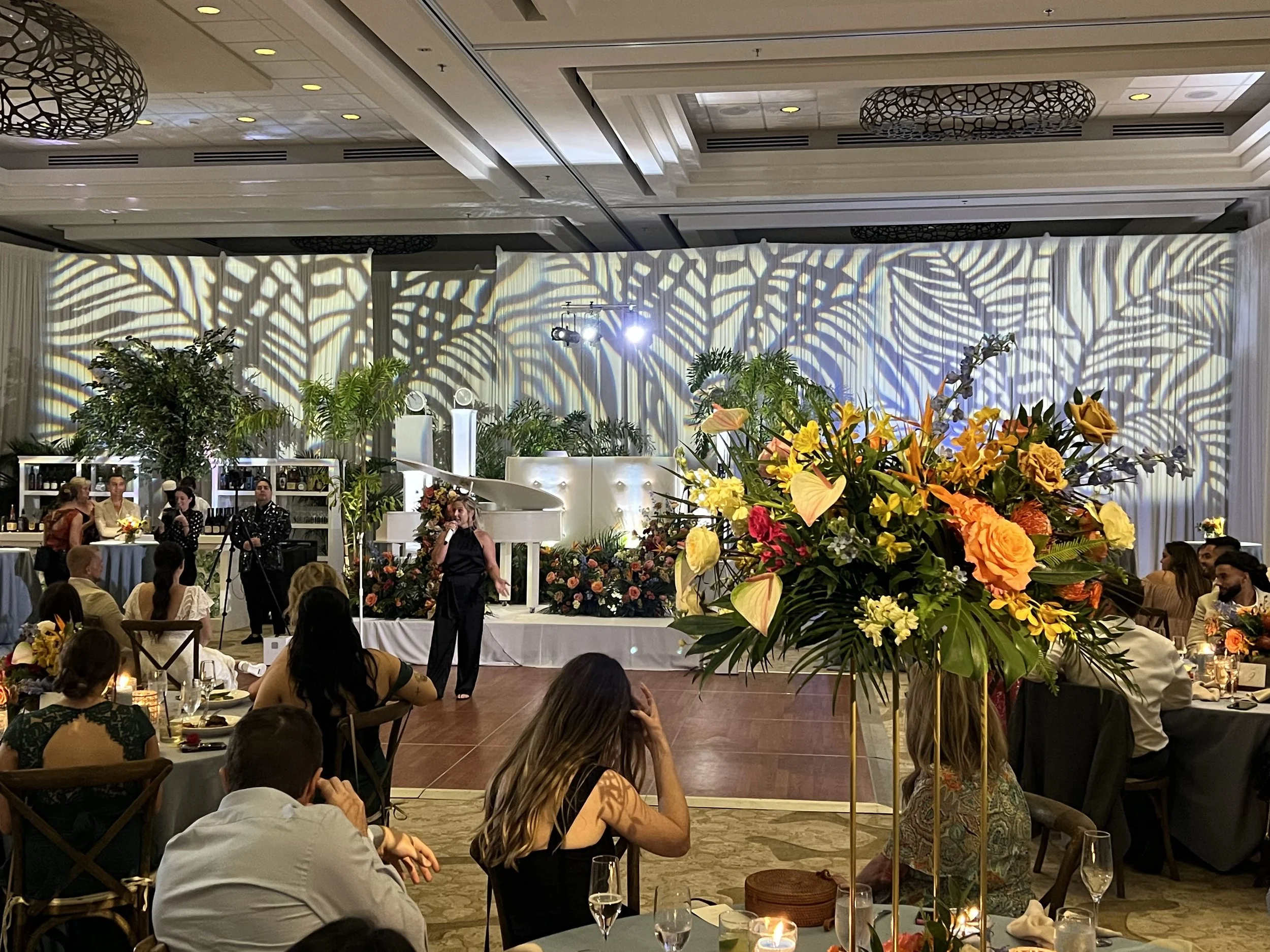 Palm leaf pattern gobo projection with piano and floral setup in Southwest Florida