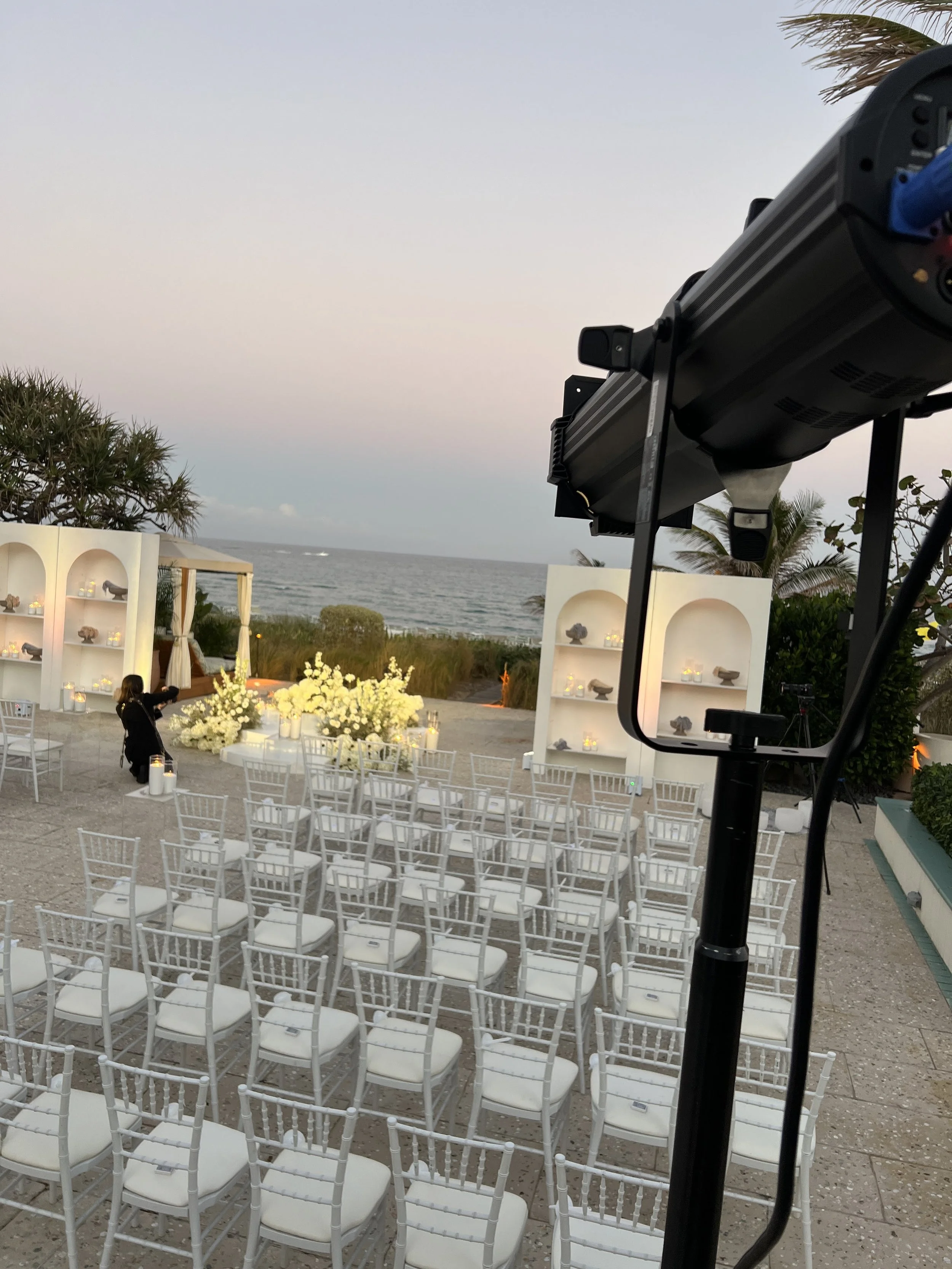 Outdoor beach wedding ceremony setup with white arches overlooking the ocean in Southwest Florida