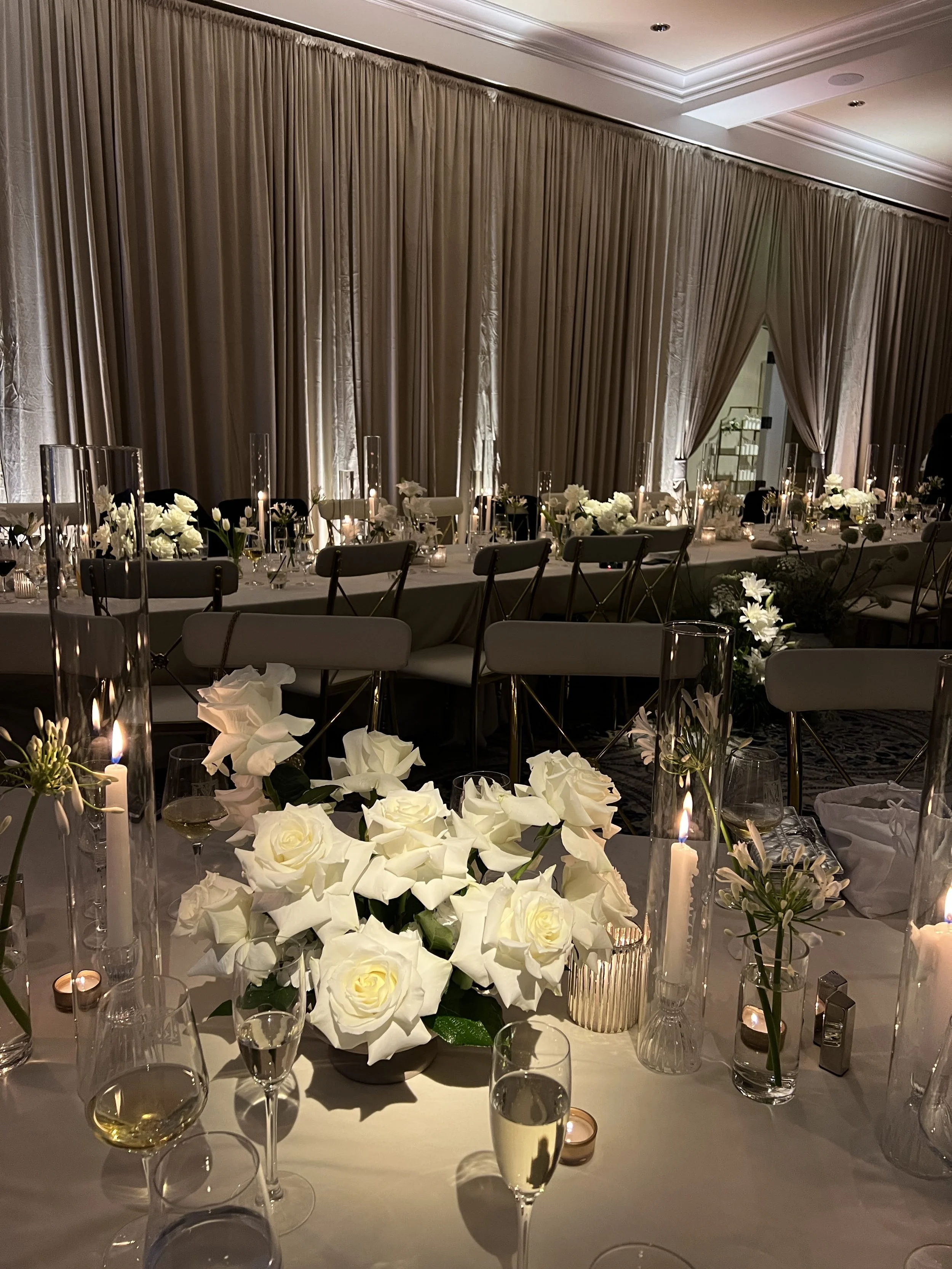 Long table setting with white roses and candles in Southwest Florida