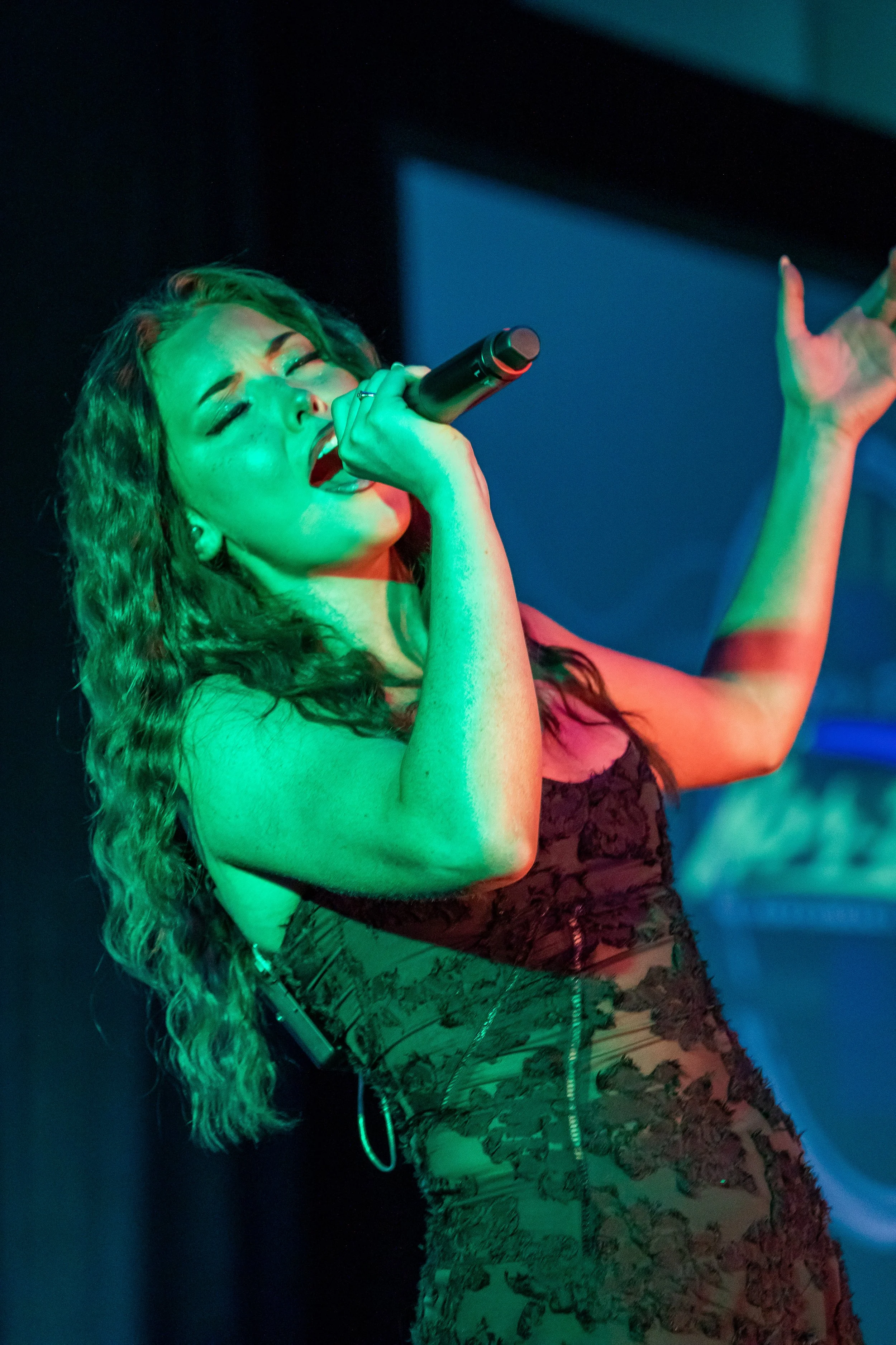 Performer under green stage lighting in Sarasota