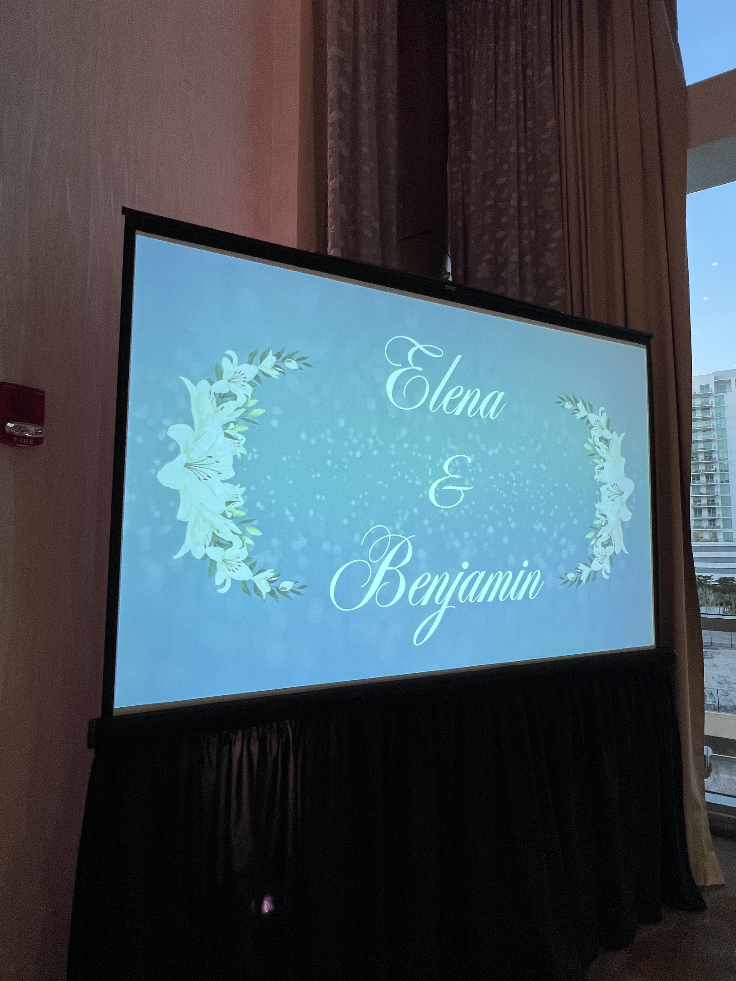 Projection screen displaying a custom wedding monogram in Southwest Florida