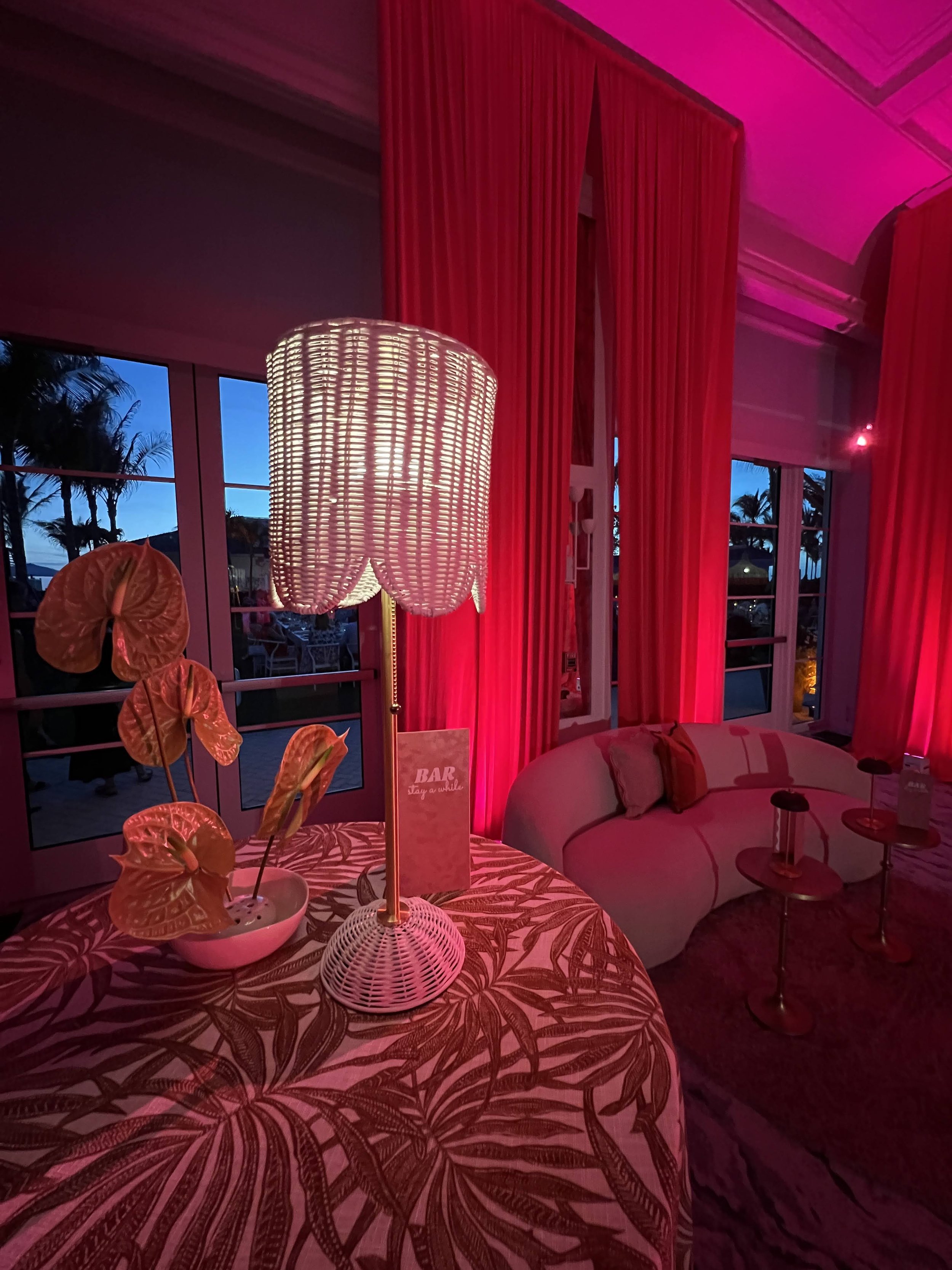 Red curtain lounge area with pink ambient uplighting in Sarasota